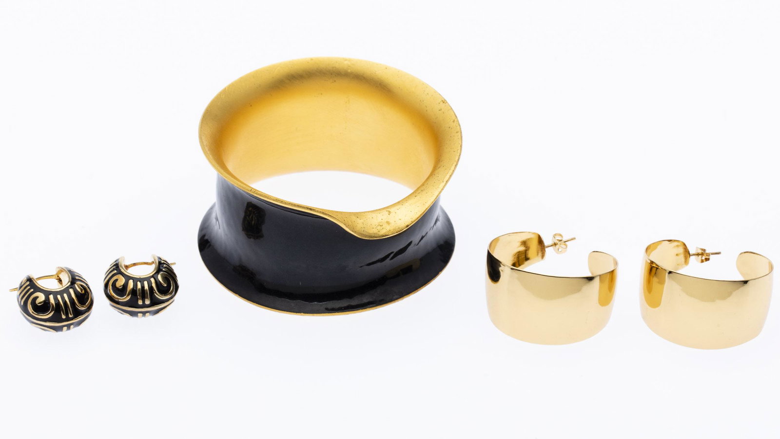 Pair of 14K Gold Earrings and Other Jewelry: Property from a Bluffton, SC Estate Description: Pair of 14K Gold Earrings and Other Jewelry, comprising a pair of black enamel and gold 14K gold earrings (4.472 dwt), pair of gilt-metal hoop earr