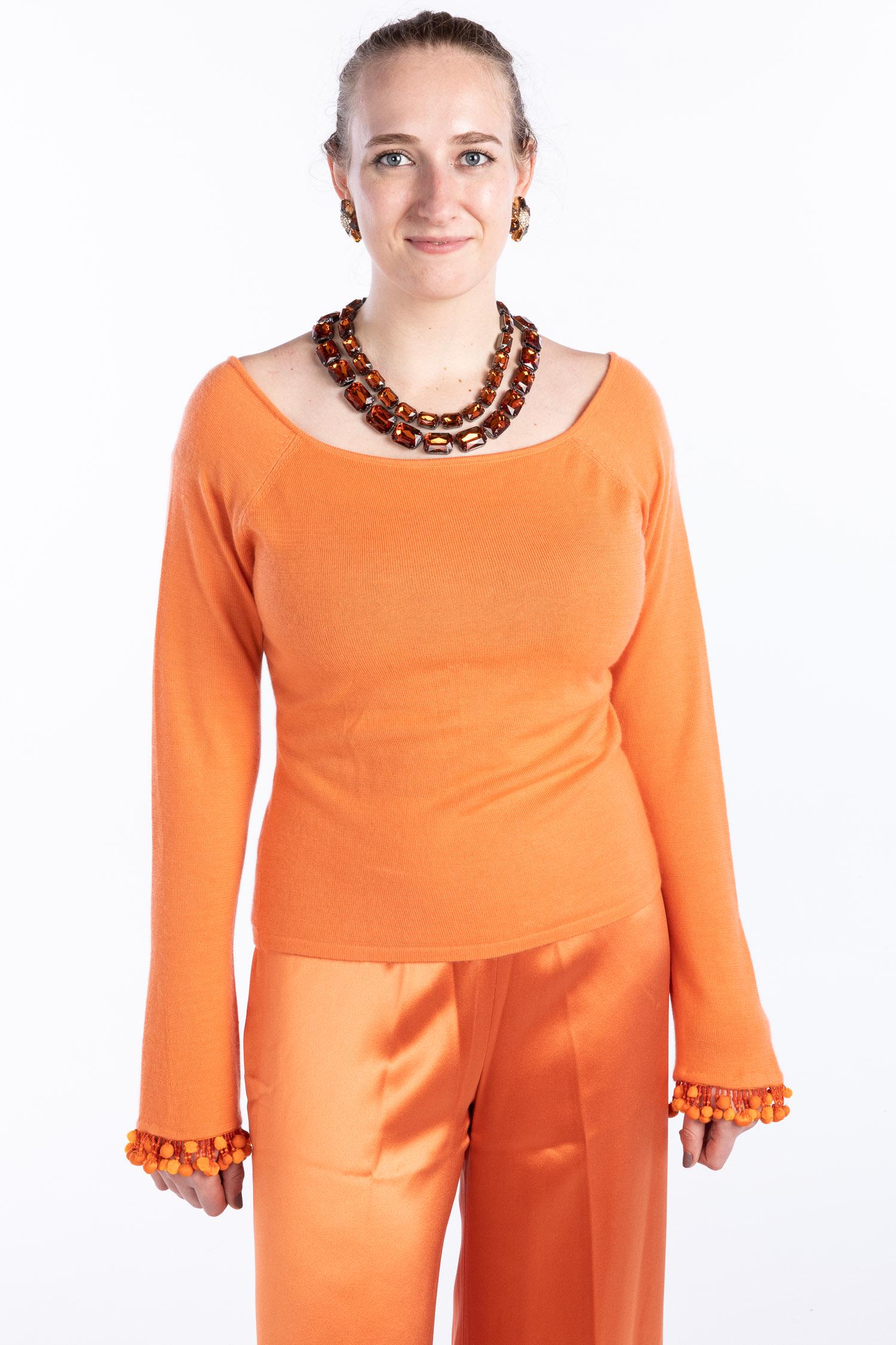 Naeem Khan Cashmere Sweater and Wide Leg Pants: Clothing and Accessories from the Estate of Jeanne Robertson Description: Naeem Khan Cashmere Sweater and Wide Leg Pants, a Naeem Khan wide bateau neck cashmere sweater with bead and pom-pom cuffs