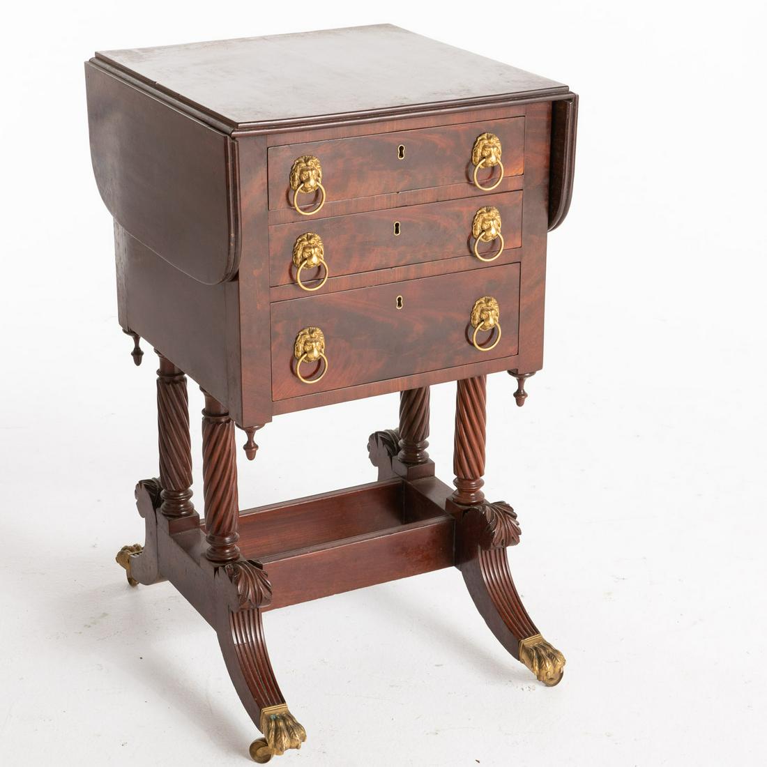Classical Mahogany Worktable, School of Phyfe: Description: Classical Mahogany Desk/Worktable, School of Duncan Phyfe, New York, c. 1815, the rectangular top with drop leaves above three drawers, the first with hinged felt-lined writing surfa