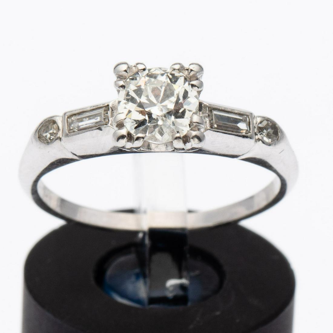 Diamond and Platinum Engagement Ring, Size 6 1/2: Property from a Bluffton, SC Estate Description: Diamond and Platinum Engagement Ring, Size 6 1/2, with central .65 carat stone G color I1,flanked by 2 single cut and 2 baguettes .20 carat, size 6