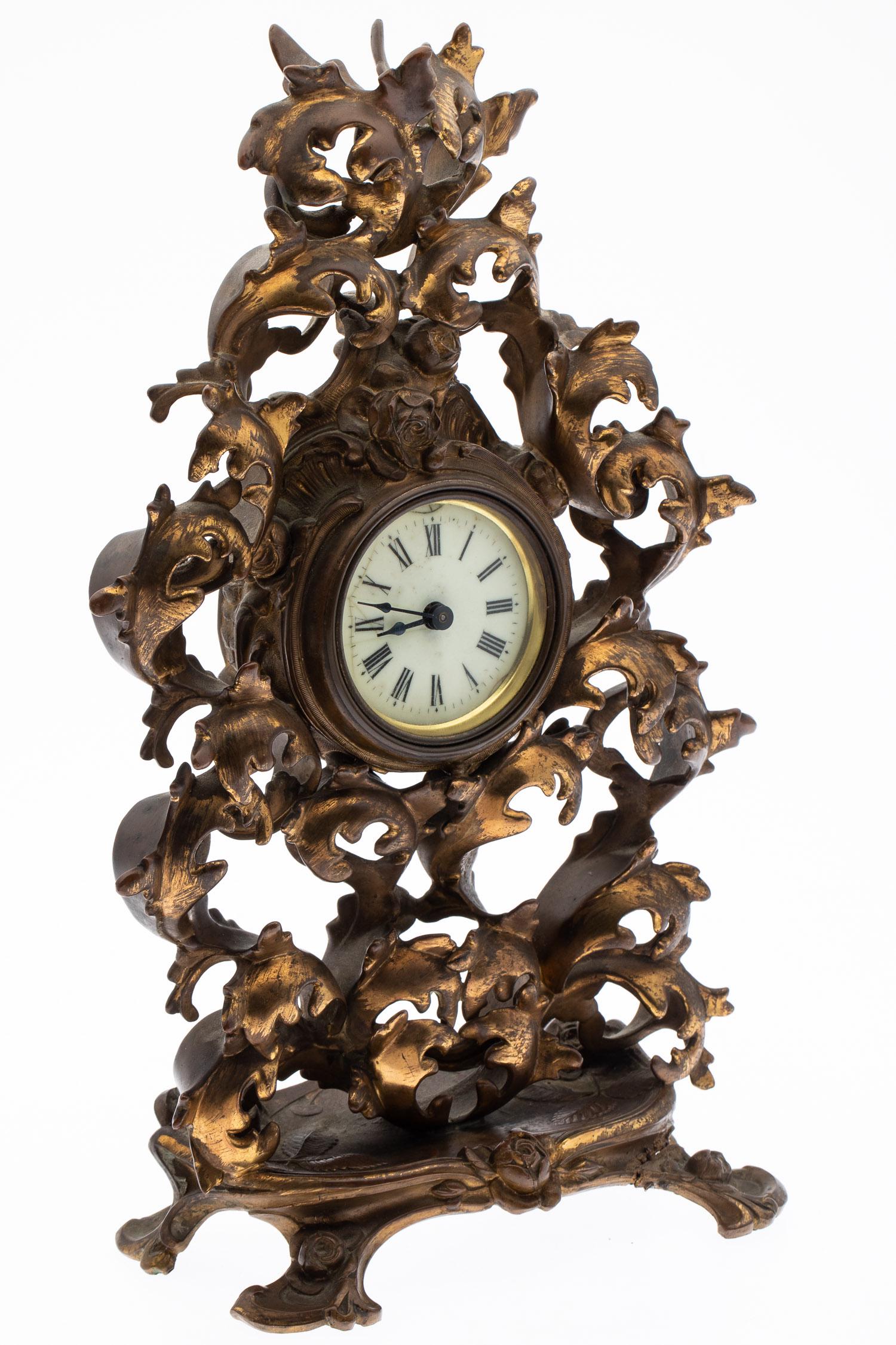 Gilt Bronze Mantle Clock: Property from a Private Collection, Savannah, GA Description: Gilt Bronze Mantle Clock, unmarked, with scrolling foliage and roses. Measurements: Height: 16 1/2 in. x Width: 10