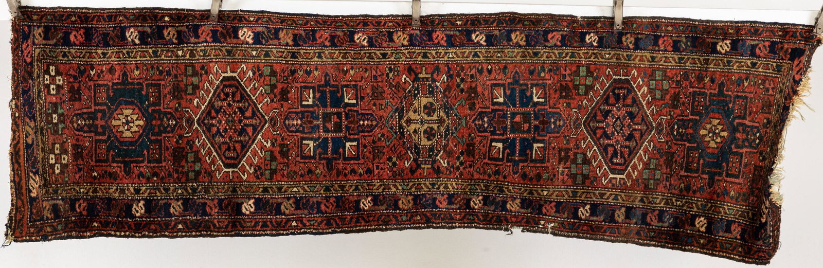 Small Persian Runner: Property from the Estate of Murray C. Perlman, Savannah, GA Description: Small Persian Runner, in tones of cream, light blue, maroon, and navy on a dark pink ground. Measurements: