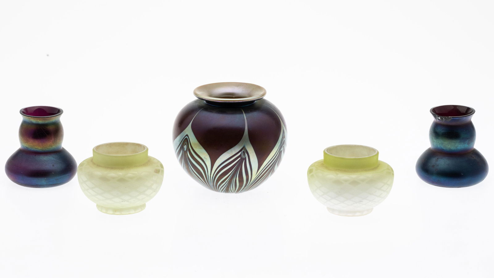 John Cook Glass Vase & 2 Pairs of Small Glass Vases: Property from the Collection of John and Virginia Duncan, Savannah, GA Description: John Cook, Phoenix Studios Art Glass Vase and 2 Pairs of Small Glass Vases, comprising a purple and multicolored