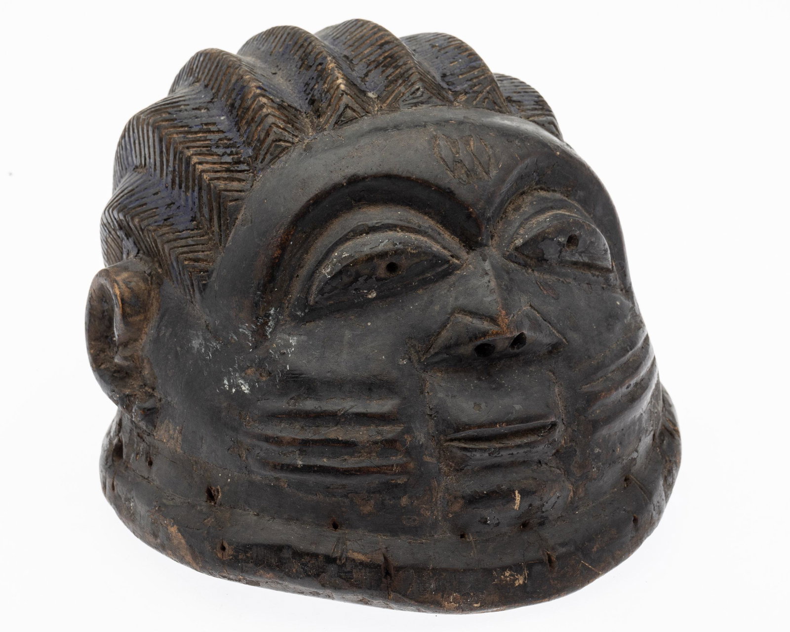 African Carved Wood Mask: Property from the Collection of John and Virginia Duncan, Savannah, GA Description: African Carved Wood Mask, carved wood mask with remnants of blue paint on braided hair. Measurements: