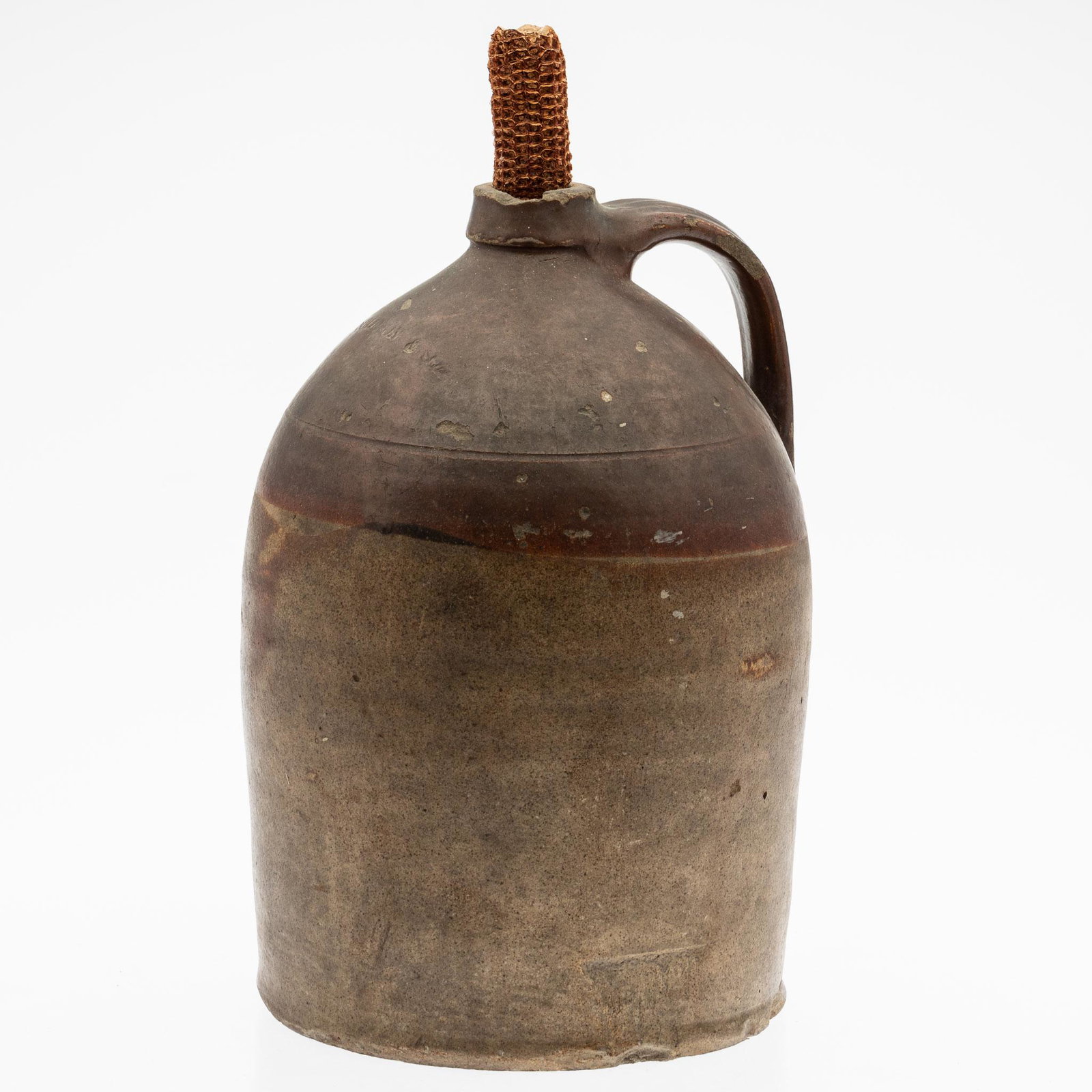 H. Solomon & Son Jug: Property from the Collection of John and Virginia Duncan, Savannah, GA Description: H. Solomon & Son Jug, with corn cob stopper and applied handle, stamped H. Solomon & Son. Measurements