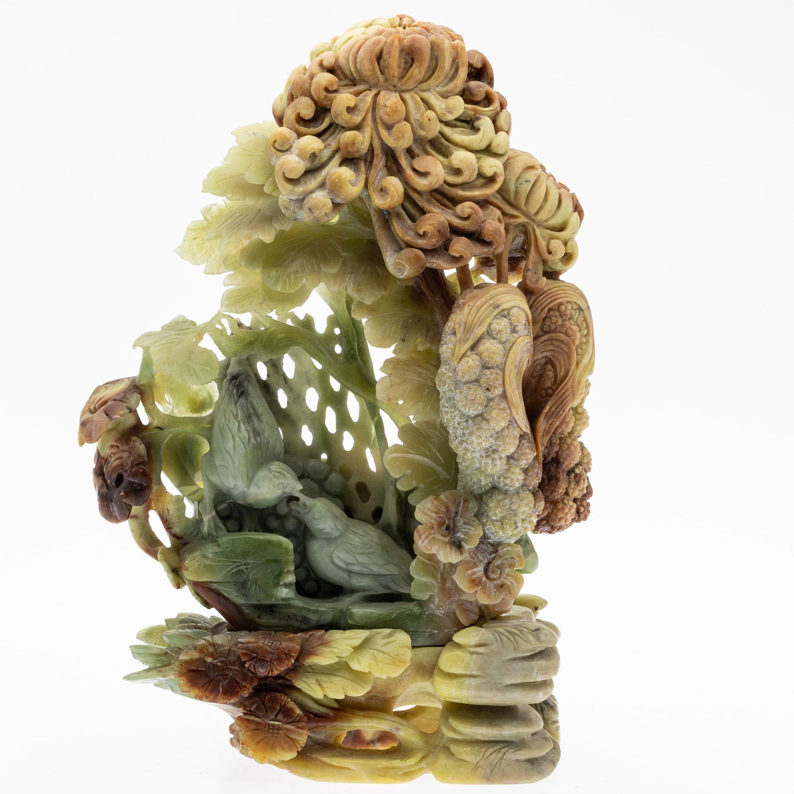 Chinese Carved Jade Sculpture: Property from a Private Collection, St. Simons Island, GA Description: Chinese Carved Jade Sculpture, with flowers, clusters of berries, and birds on a separate flower and rock form base. Together