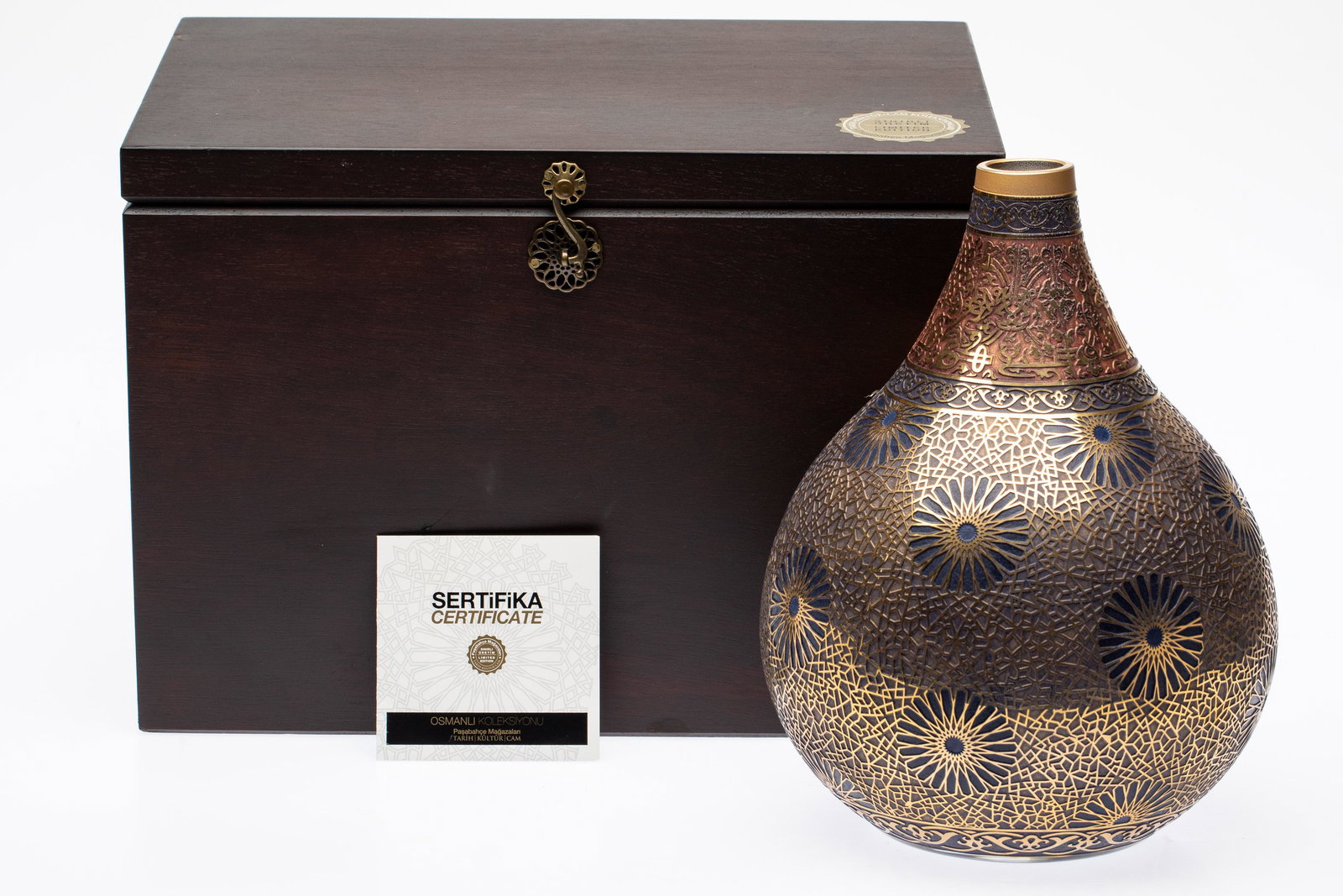 Kozmik Yildiz,Turkish Glass Vase Pasabahce Magazalan: Property of a Okatie, SC Estate Description: Kozmik Yildiz, Turkish Glass Vase Pasabahce Magazalan, with raised gilt motifs on blue, gold and red ground, etched 'Pasabahce Magazalan, 2000/1033' on