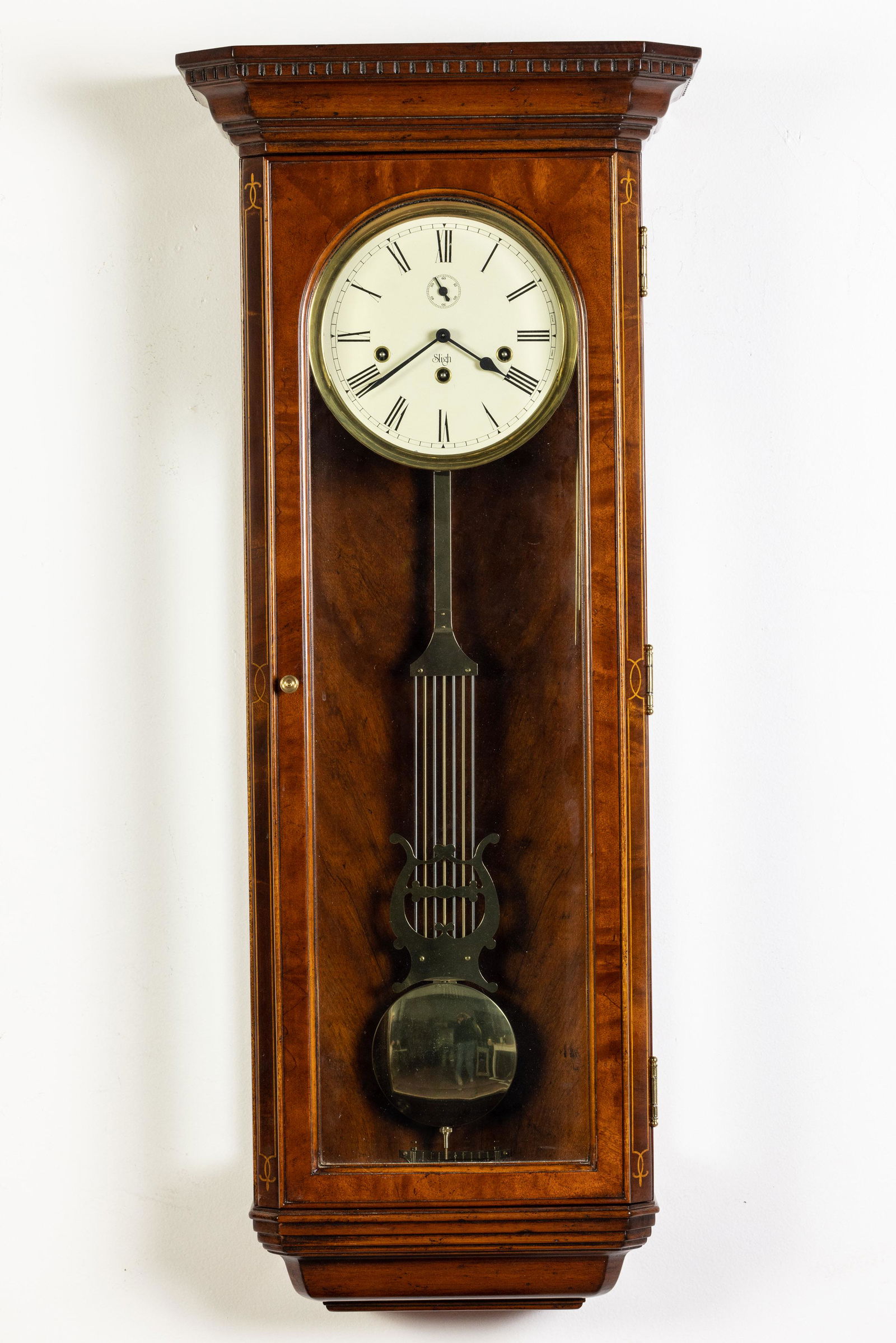 Sligh Inlaid Walnut Wall Clock: Property of a Okatie, SC Estate Description: Sligh Inlaid Walnut Wall Clock, with seconds dial and glazed door. Measurements: Height: 38 in. x Width: 12 in. x Depth: 6 in.