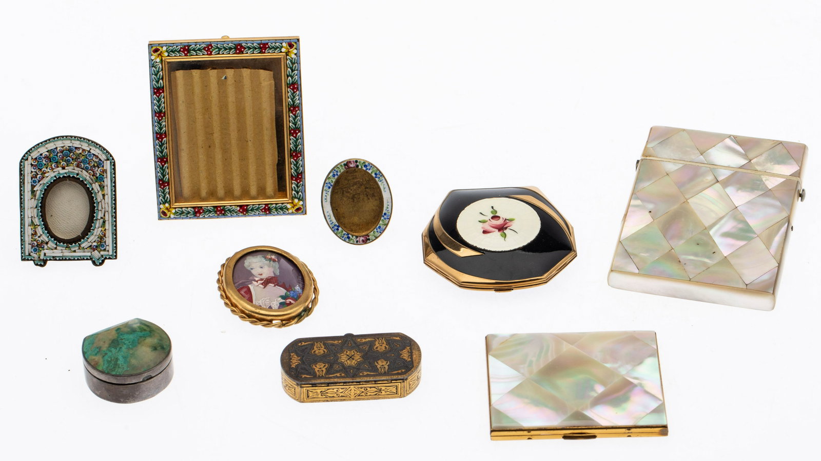 9 Metal and Mother-of-Pearl Table Articles: Property from an Estate, Chicago and Savannah Description: 9 Metal and Mother-of-Pearl Table Articles, comprising a mother of pearl cigarette case (some chips, cracks on spine) a mother of pearl a