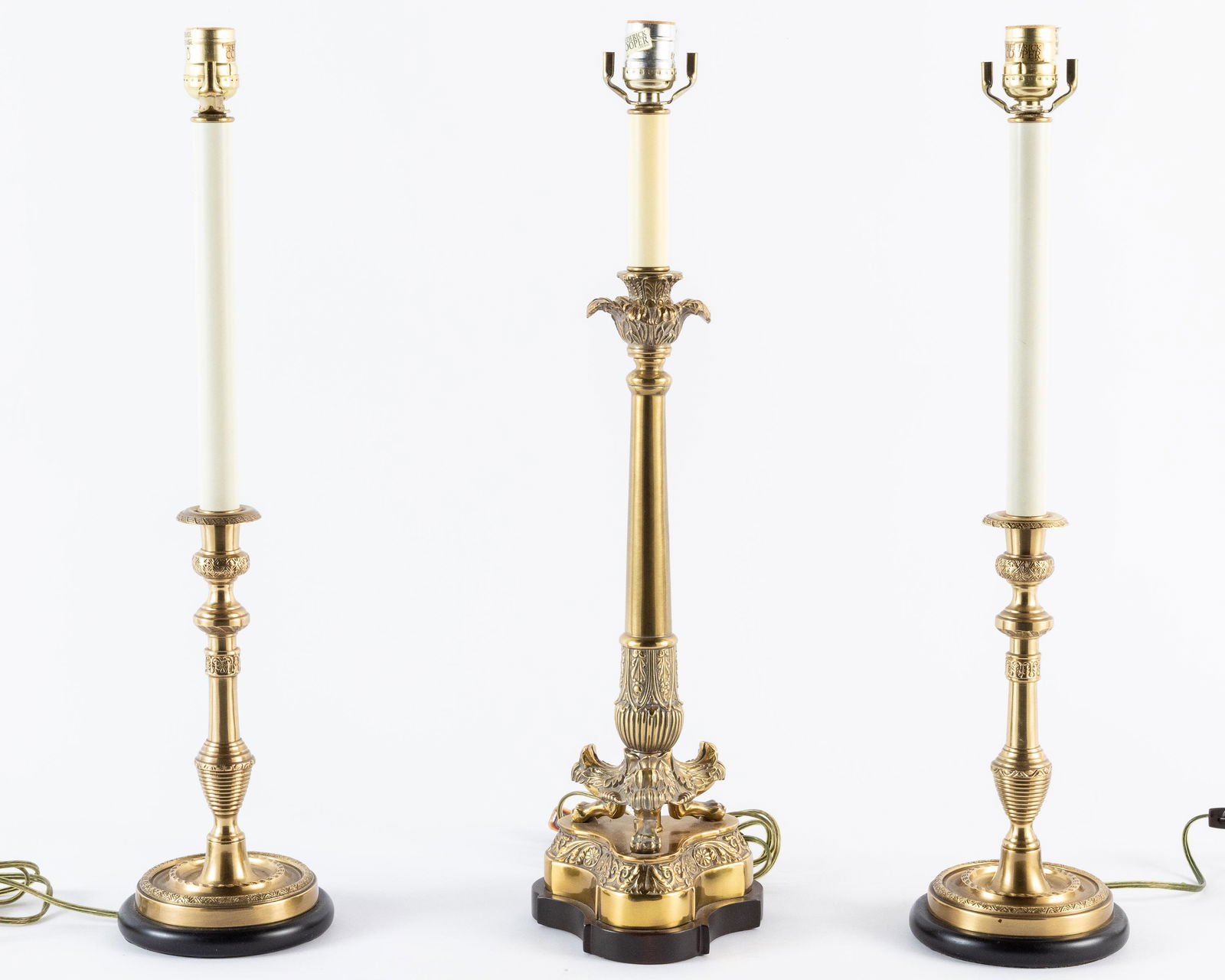 3 Brass Candlestick Table Lamps: Property of a Okatie, SC Estate Description: 3 Brass Candlestick Table Lamps, a pair of circular brass candlestick lamps and a three footed candlestick lamp, with Frederick Cooper Chicago labels o