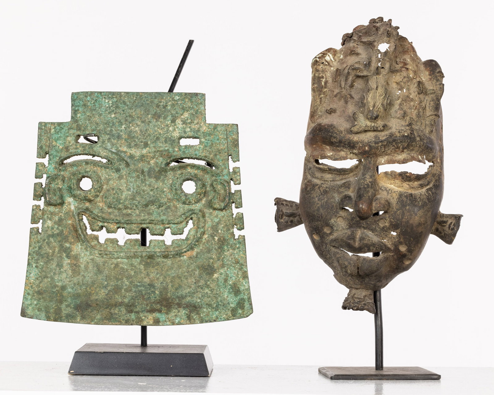 African Metal Mask and Another Bronze: Property from the Estate of David Rapkin Description: African Metal Mask and Another Bronze, a metal mask, probably Nigerian, with crocodile headdress, together with a flat bronze blade shaped art