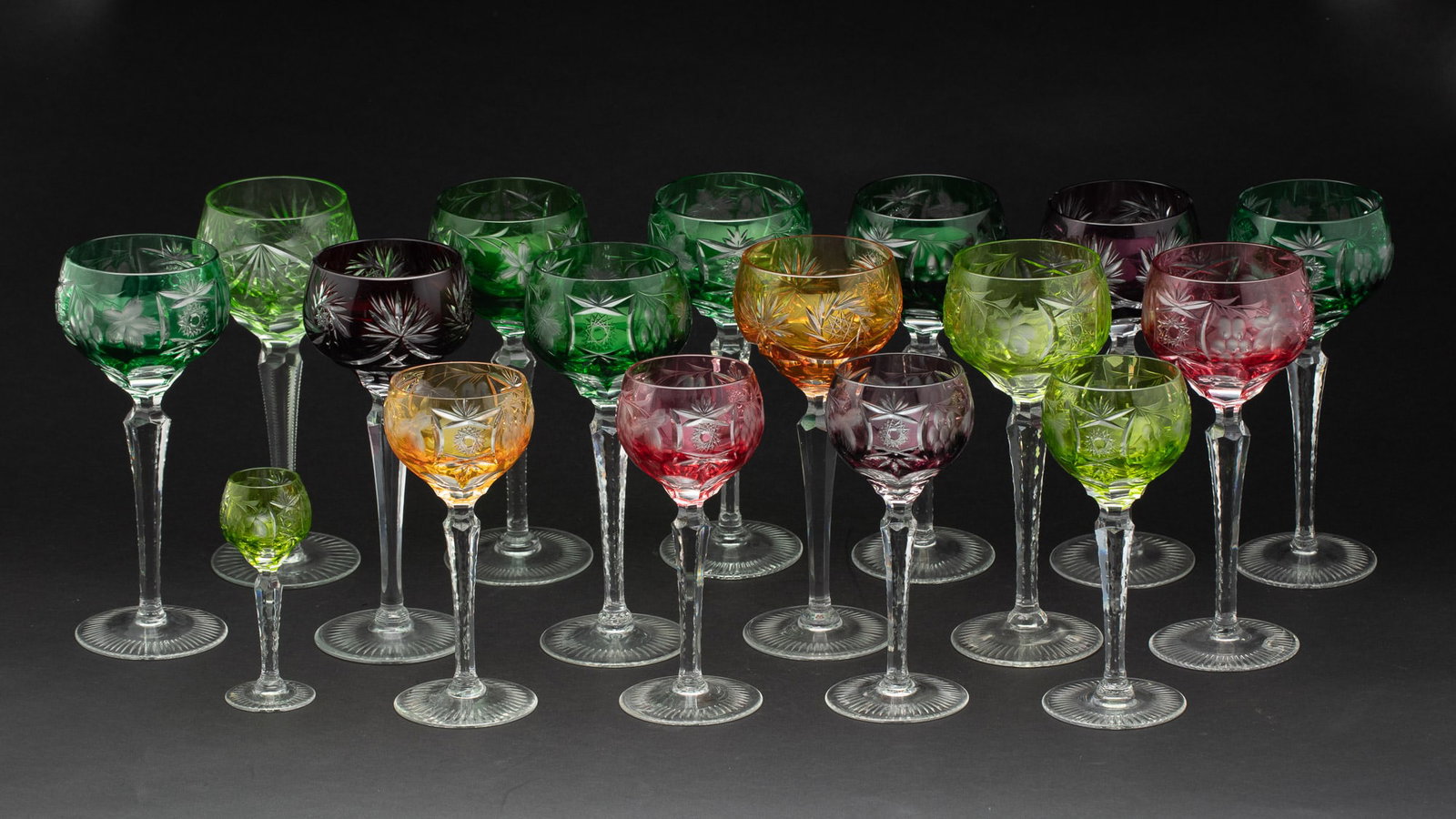 Set of Bohemian Colored Glass Wine Glasses, 17 pcs.: Description: Set of Bohemian Colored Glass Wine Glasses, 17 pcs., comprising 12 red wine glasses, 4 white wine glasses and one sherry glass, all cut glass with floral designs, the bowls in variou