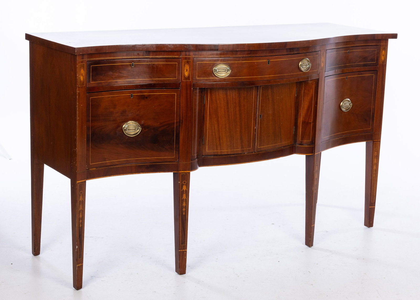 Federal Style Mahogany Sideboard: Property from the Estate of Jeannie Sims, Savannah, GA and Charleston, SC Description: Federal Style Mahogany Sideboard, with an arrangement of drawers around cupboard doors, raised on square tape