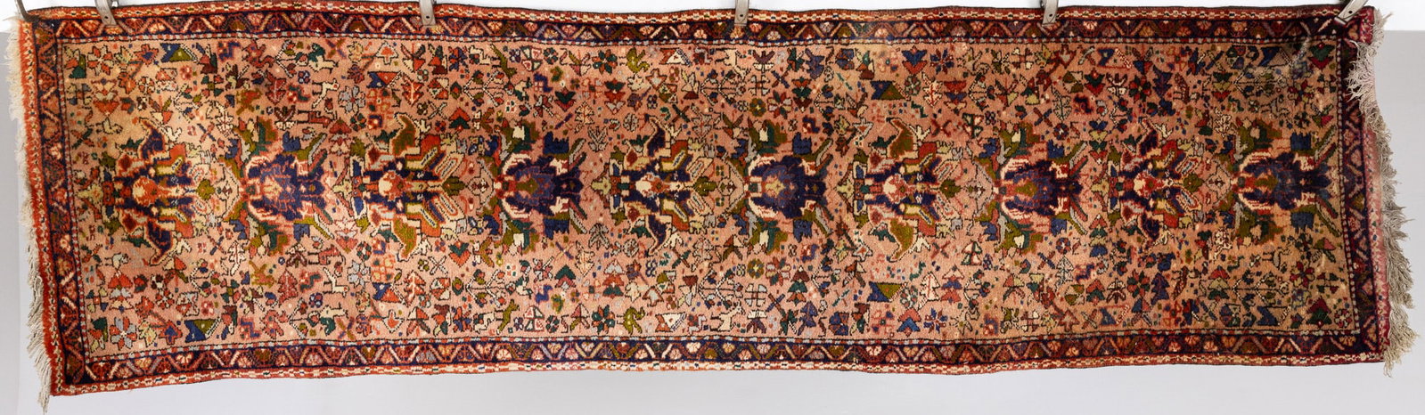 Persian Runner: Description: Persian Runner, in tones of dark blue, cream, green, light blue, and red on a pink ground. Measurements: Length: 8 ft. 9 in. x Width: 28 3/4 in.