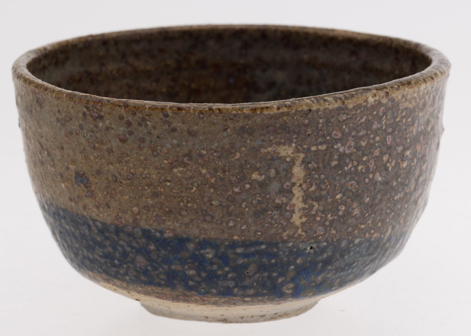 Toshiko Takaezu (1922-2011), Brown Glazed and Blue Tea Bowl: Property of Private Collection, SC Description: Toshiko Takaezu (American/Japanese, 1922-2011), Brown Glazed and Blue Tea Bowl, signed underneath with artists monogram initials TT, with spotted br