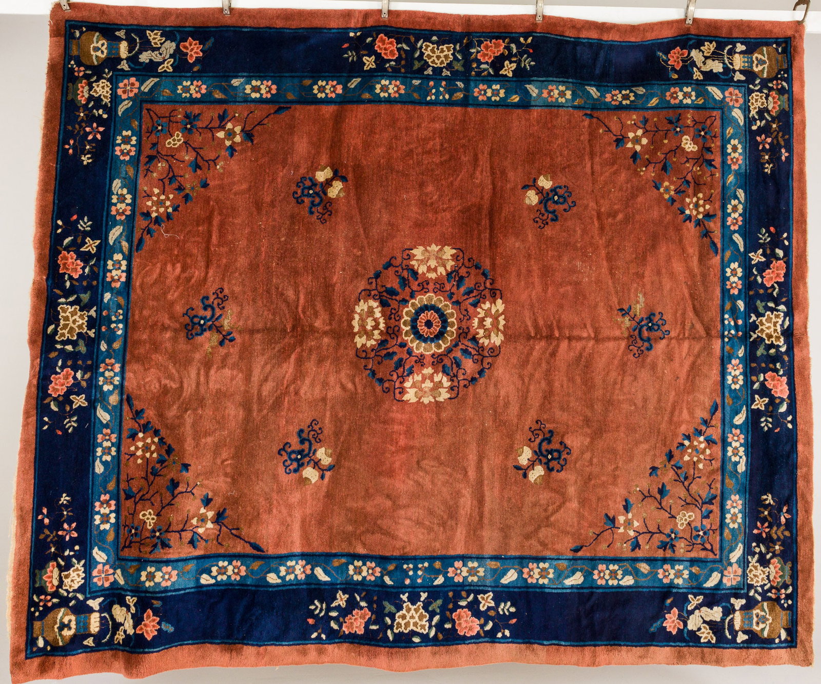 Chinese Nichols Rug: Description: Chinese Nichols Rug, in tones of light blue, cream, light brown, and dark blue with a mocha ground, decorated with floral motif with vases and urns of flowers. Measurement