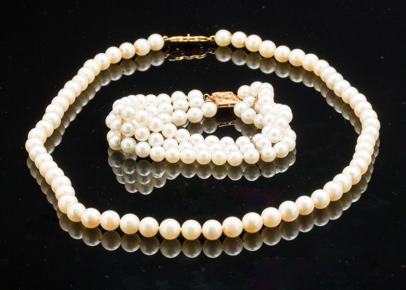 Pearl Necklace and 3-Strand Pearl Bracelet: Property from a Private Collection, Savannah, GA Description: Pearl Necklace and 3-Strand Pearl Bracelet, a Mikimoto single strand pearl necklace, pearls approximately 6.7 mm, with 18k yellow gold