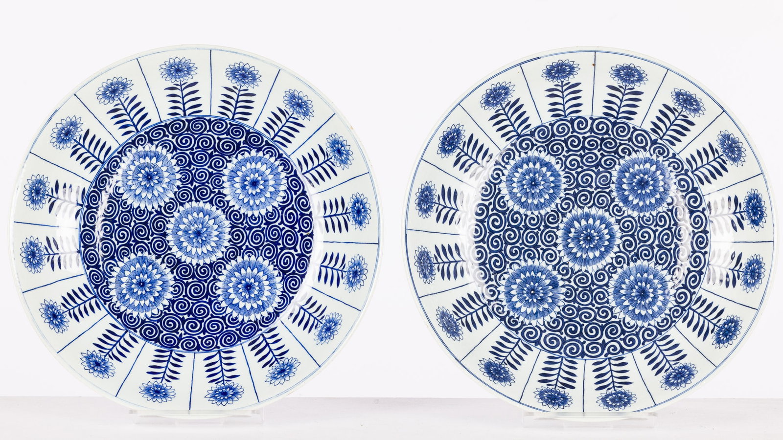 Pair of Chinese Blue and White Aster Chargers: Property from the Ira and Nancy Koger Estate Description: Pair of Chinese Blue and White Aster Chargers, each decorated with flowers and with six character mark on the undersides. Measur