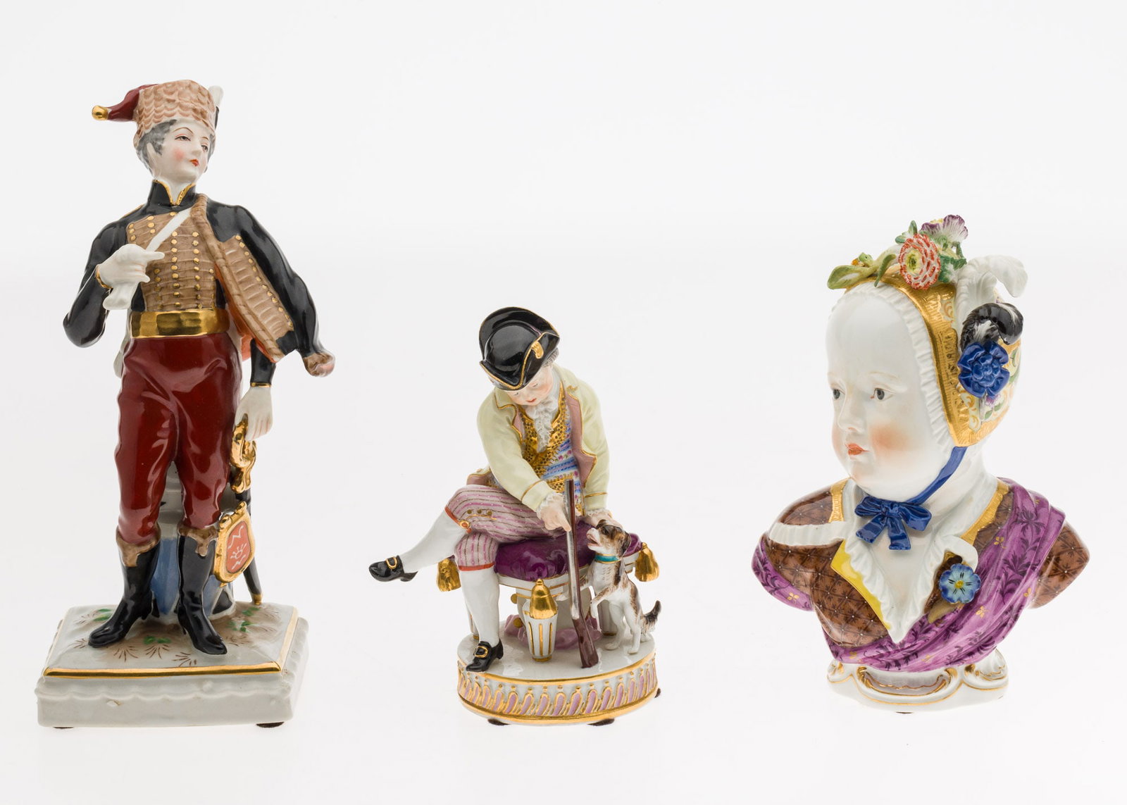 Two Meissen Porcelain Figures and a Drummer Figure: Description: Two Meissen Porcelain Figures and a Drummer Figure, comprising a Meissen seated figure with shotgun and dog, marked and numbered 'F 50, 127' on underside, a Meissen bust of a woman i