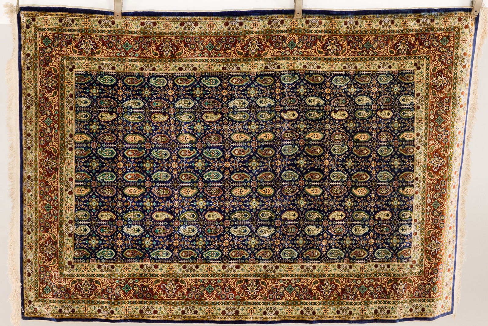 Persian Silk Rug: Property of a Hilton Head Island, SC Estate Description: Persian Silk Rug, featuring a paisley design, densely populated on a navy field surrounded by consecutive rectangular borders. Me