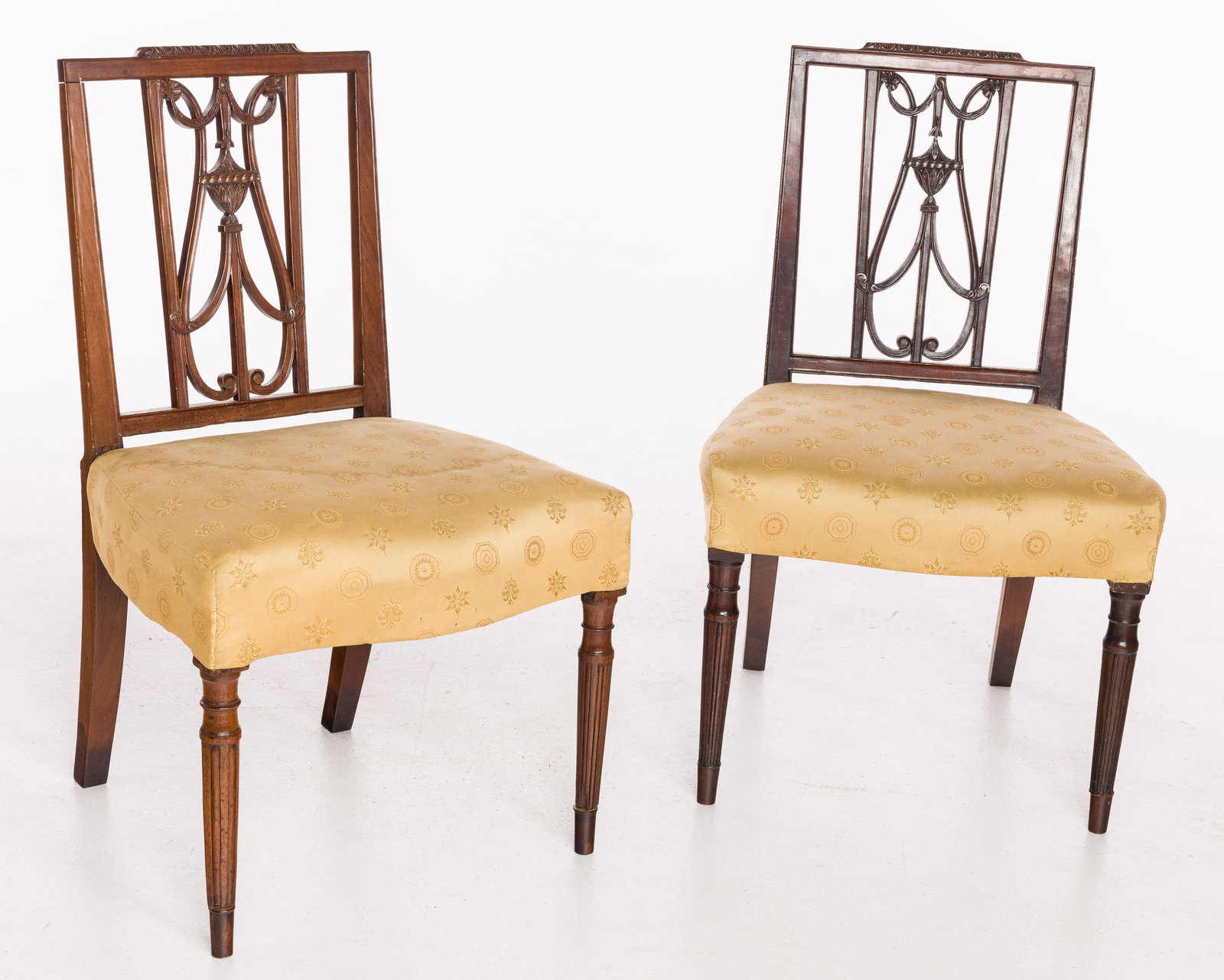 Pair of Federal Mahogany Side Chairs, c. 1800: Property De-Accessioned from the Telfair Museums, Savannah, GA Description: Pair of Federal Mahogany Side Chairs, c. 1800, each with urn and swag carved back above an overupholestered seat raised
