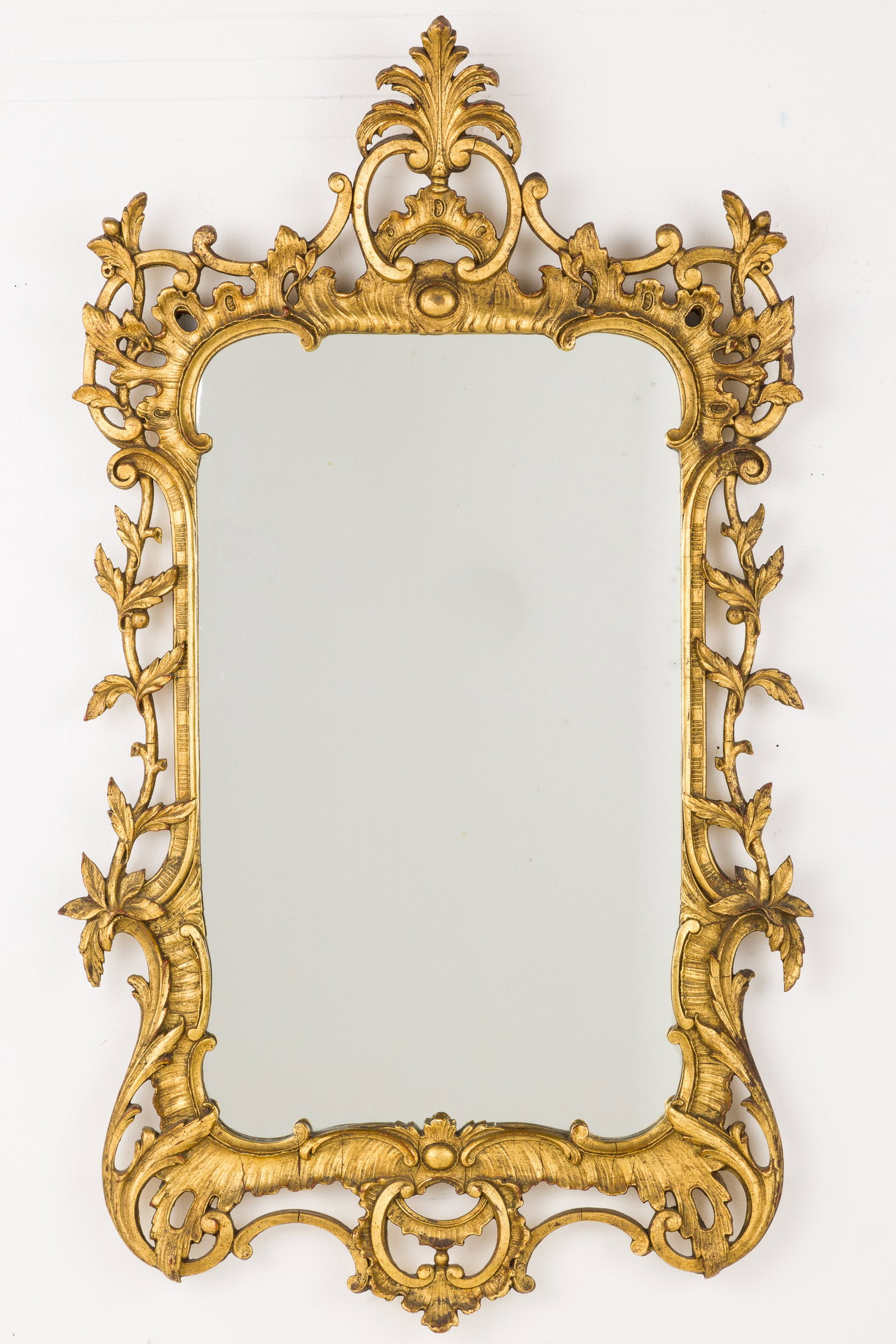 George III Style Giltwood Mirror: Property from the Estate of Ann Lytle, Savannah, GA Description: George III Style Giltwood Mirror, with shaped rectangular mirrorplate within a pierced surround carved with C-scrolls and scrolling