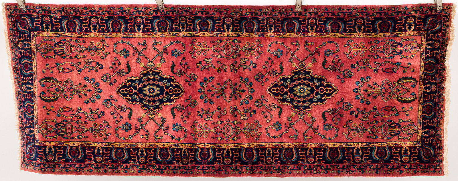Small Persian Runner: Property from the Estate of Ann Lytle, Savannah, GA Description: Small Persian Runner, in tones of dark blue, light blue and cream on a raspberry ground with dark blue border. Measuremen