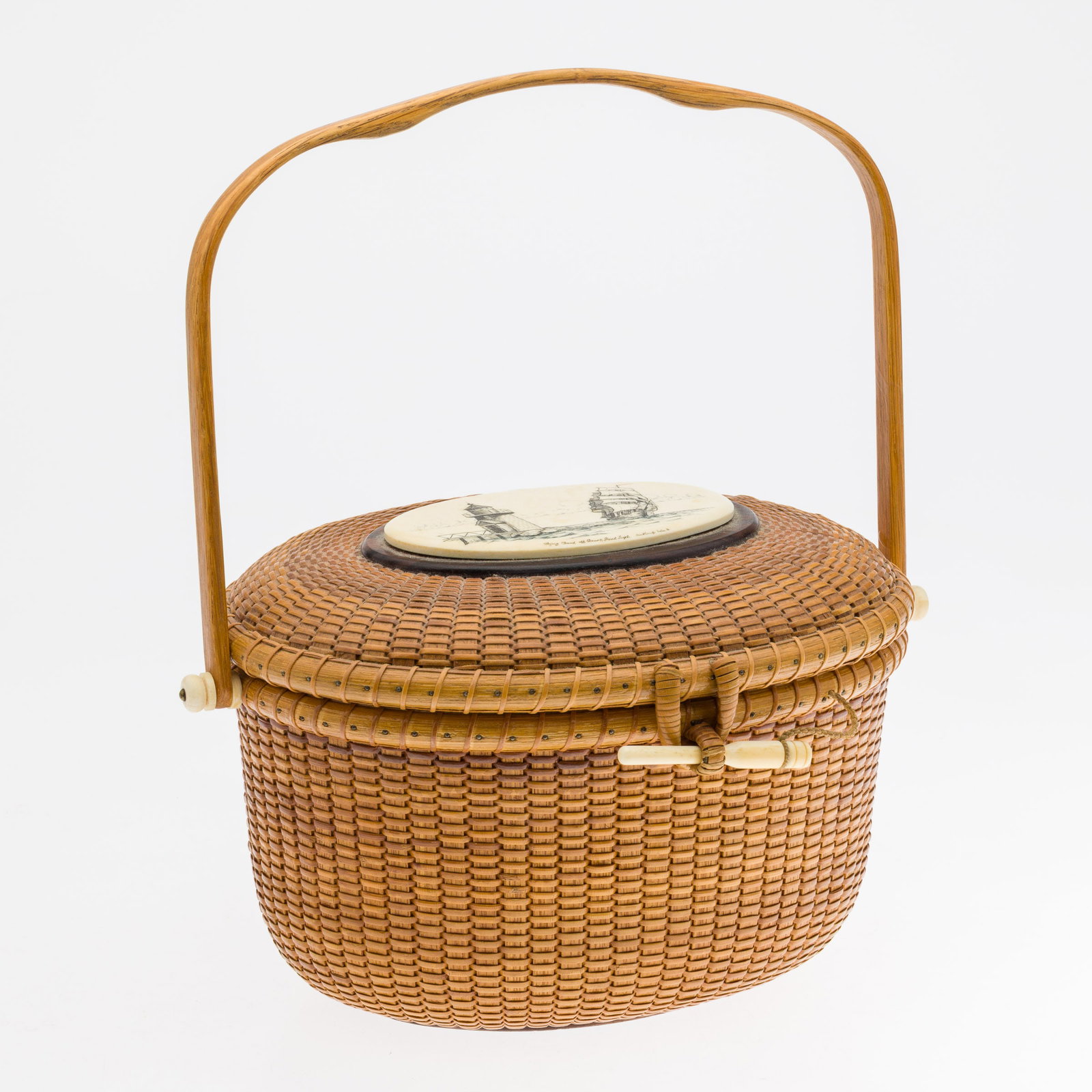 Martin Brown Nantucket Scrimshaw Basket: Property from a Hilton Head Island Estate, SC Description: Martin Brown Nantucket Scrimshaw Basket, lidded basket with handle, mounted with carved scrimshaw panel of ship and lighthouse, captioned