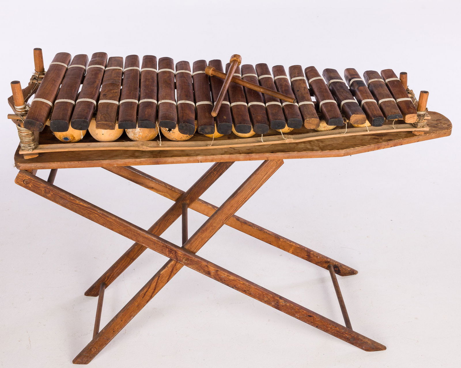 Mandingo Balafon (Xylophone): Property of Belinda McLain and the Hector Dewart Estate Description: Mandingo Balafon (Xylophone), with two mallets, the bars over calabash, on a wood ironing board stand. Measurements: