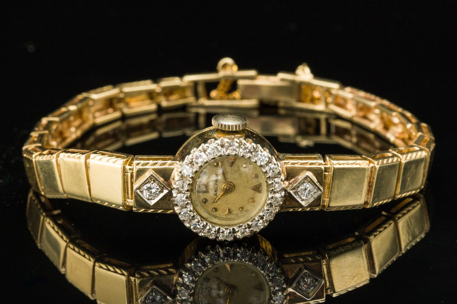 Blancpain 14K and Diamond Ladies Watch: Description: Blancpain 14K and Diamond Ladies Watch, ladies watch with round champagne dial framed by 18 round cut approximately 1.7 mm diamonds and flaked by two approximately 2.35 mm round cut