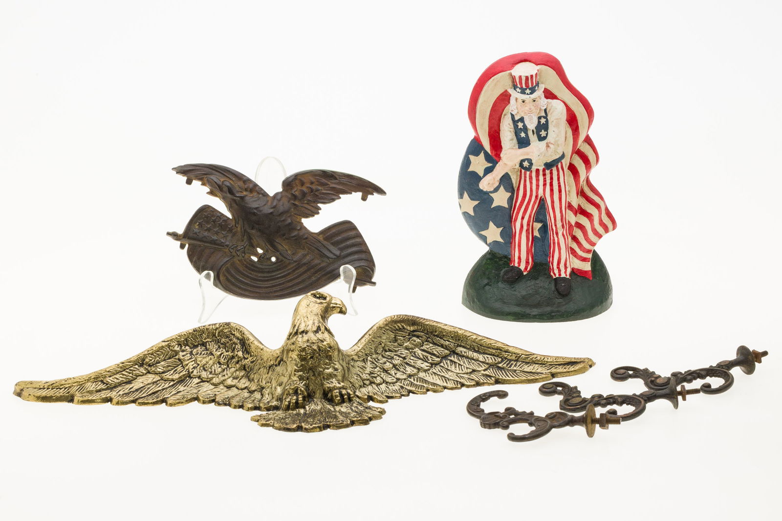 2 Eagle Wall Hangings, Uncle Sam Doorstop & Hinges: Property from the Estate of Judge Joel M. Flaum, Chicago, IL Description: Two Eagle Wall Hangings, an Uncle Sam Doorstop and Antique Hinges, comprising a gilt metal eagle wall hanging, numbered '0