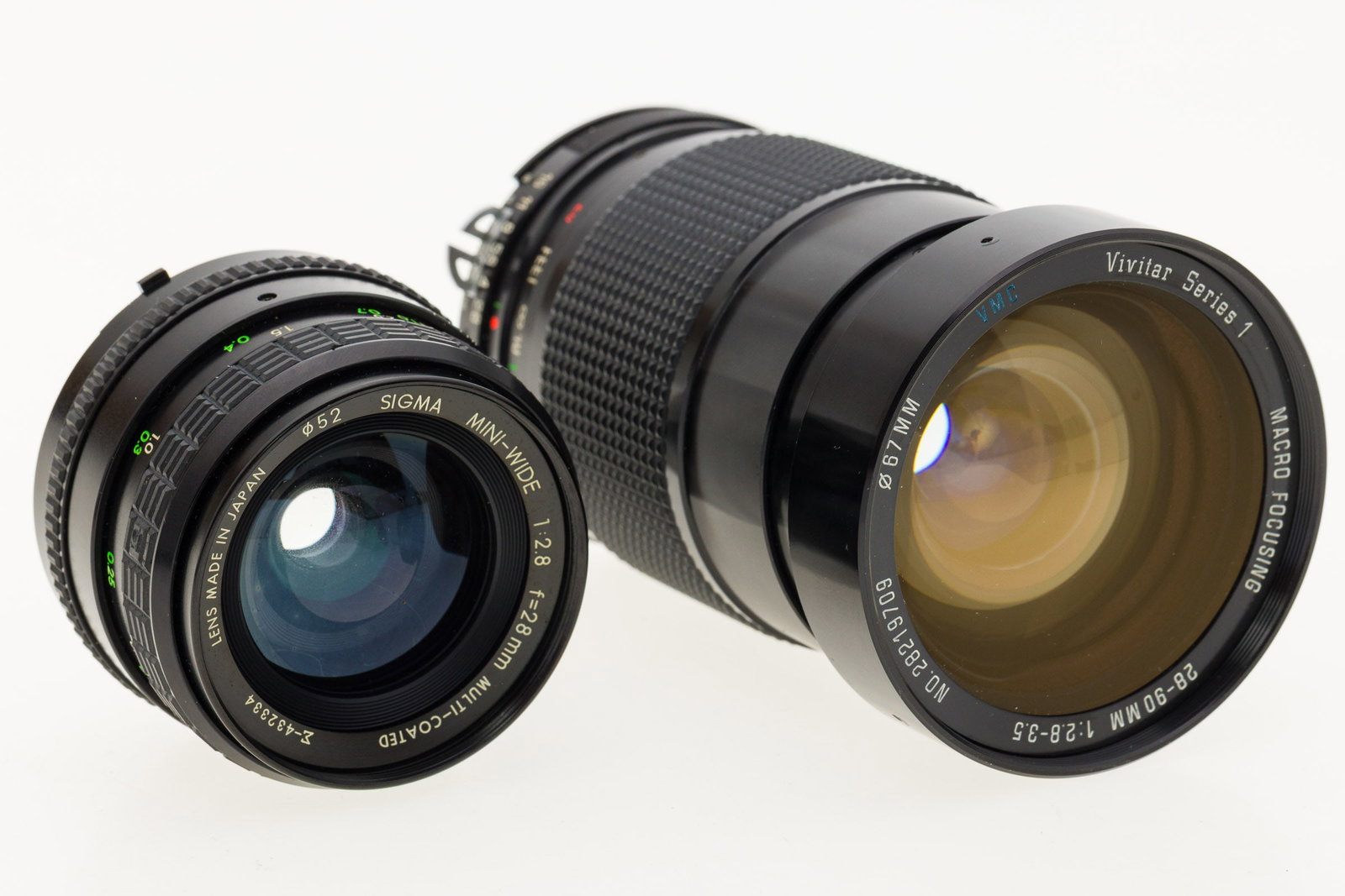 Sigma Mini-Wide and Vivitar Series 1 Lenses: Property from the Collection of Ray C. Cottingham Description: Sigma Mini-Wide and Vivitar Series 1 Lenses, a Vivitar Series 1, Macro focusing, 28-90mm, f2.8-3.5, SN 28219709, VMC, and a Sigma min