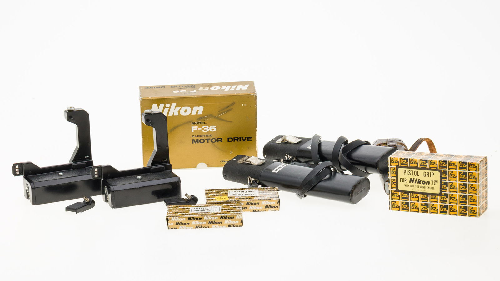 Group of Nikon Accessories, 8 pcs.: Property from the Collection of Ray C. Cottingham Description: Group of Nikon Accessories, 8 pcs. , comprising a Nikon F-36 electric motor drive (148911), three remote battery packs, pistol grip f