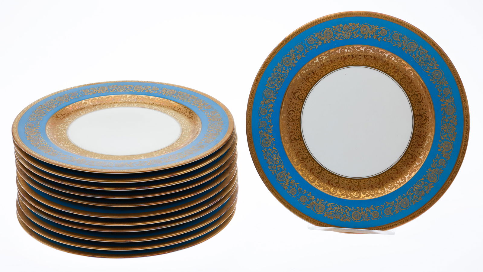 12 Limoges Blue and Gold Porcelain Dinner Plates: Description: 12 Limoges Blue and Gold Porcelain Dinner Plates, each with light blue and elegant gilt rim, marked with red bell and 'Limoges France'. Measurements: Diameter: 11