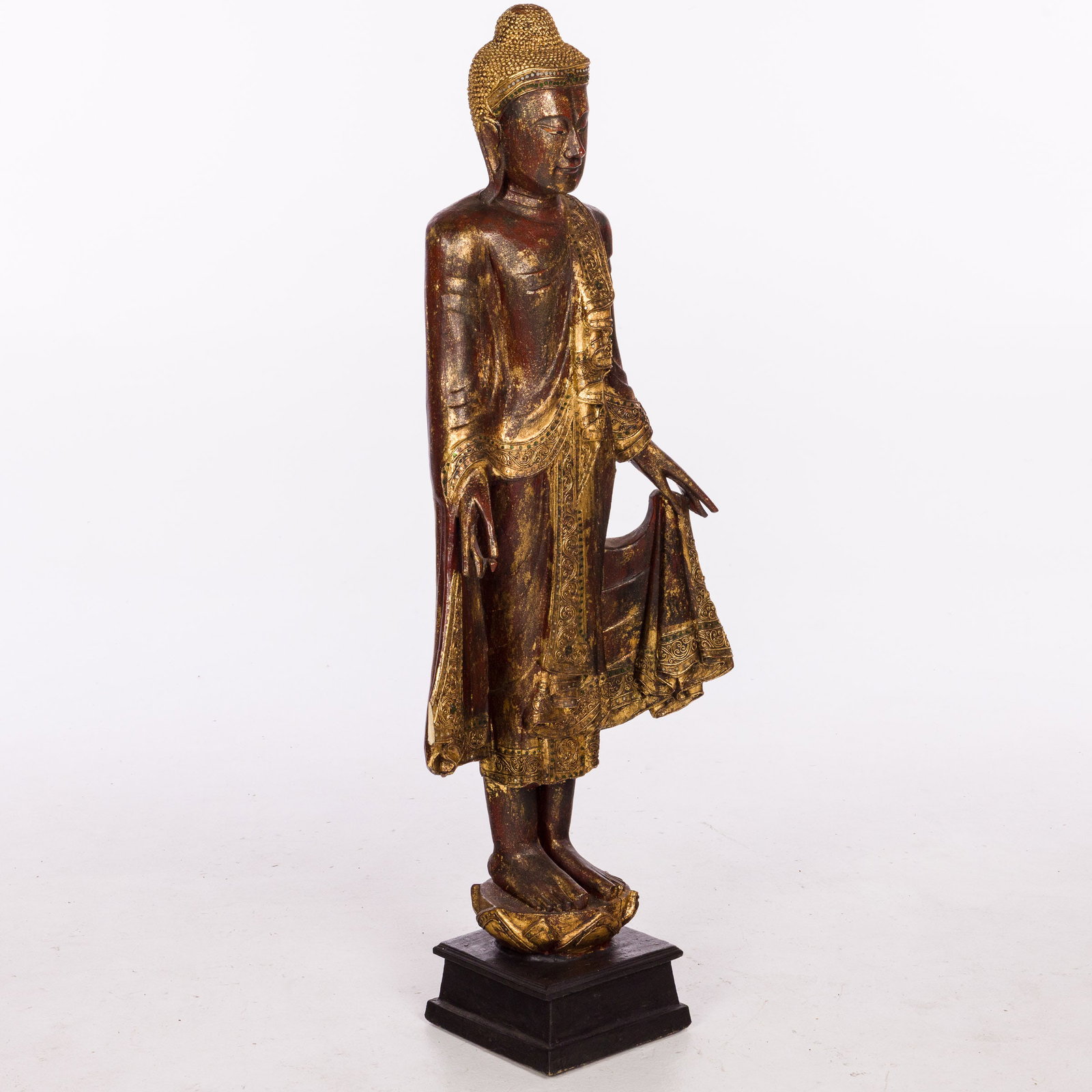 Vintage Tibetan Style Standing Figure: Description: Vintage Tibetan Style Standing Figure, the figure holding it's robe and standing on a lotus further on a square base. Measurements: Height: overall 56 1/4 in. x Wi