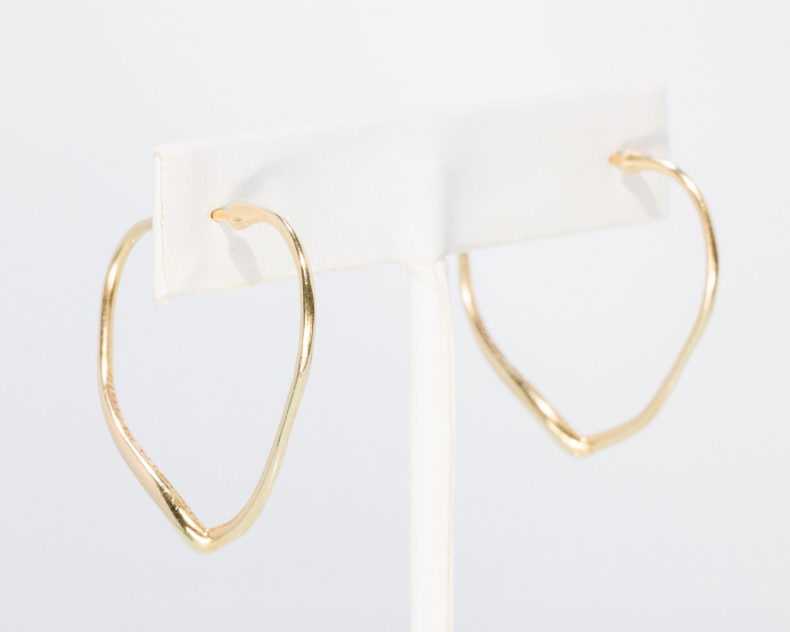 Elsa Peretti for Tiffany & Co Gold Heart Earrings: Property of an Atlanta Collector Description: Elsa Peretti for Tiffany & Co Gold Heart Earrings, 18K yellow gold heart-form hoop earrings, each marked 'Tiffany & Co, 18K, Peretti', together with o