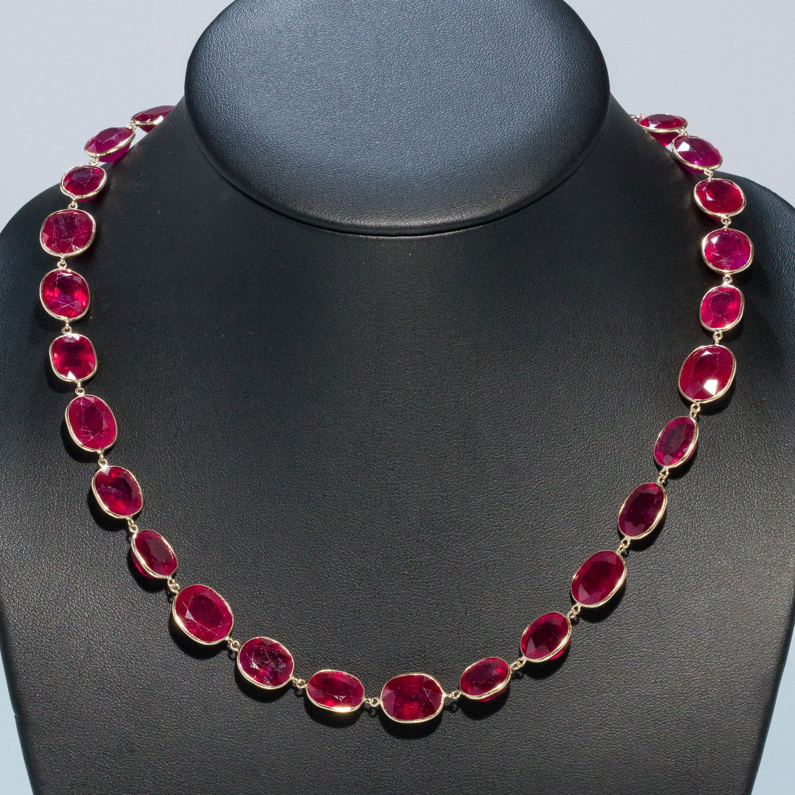 Ruby and 14K Gold Necklace: Description: Ruby and 14K Gold Necklace , 14K yellow gold with faceted pink rubies of various sizes and forms, the lobster claw clasp marked '585'. 56.12 grams overall. Measurements: </