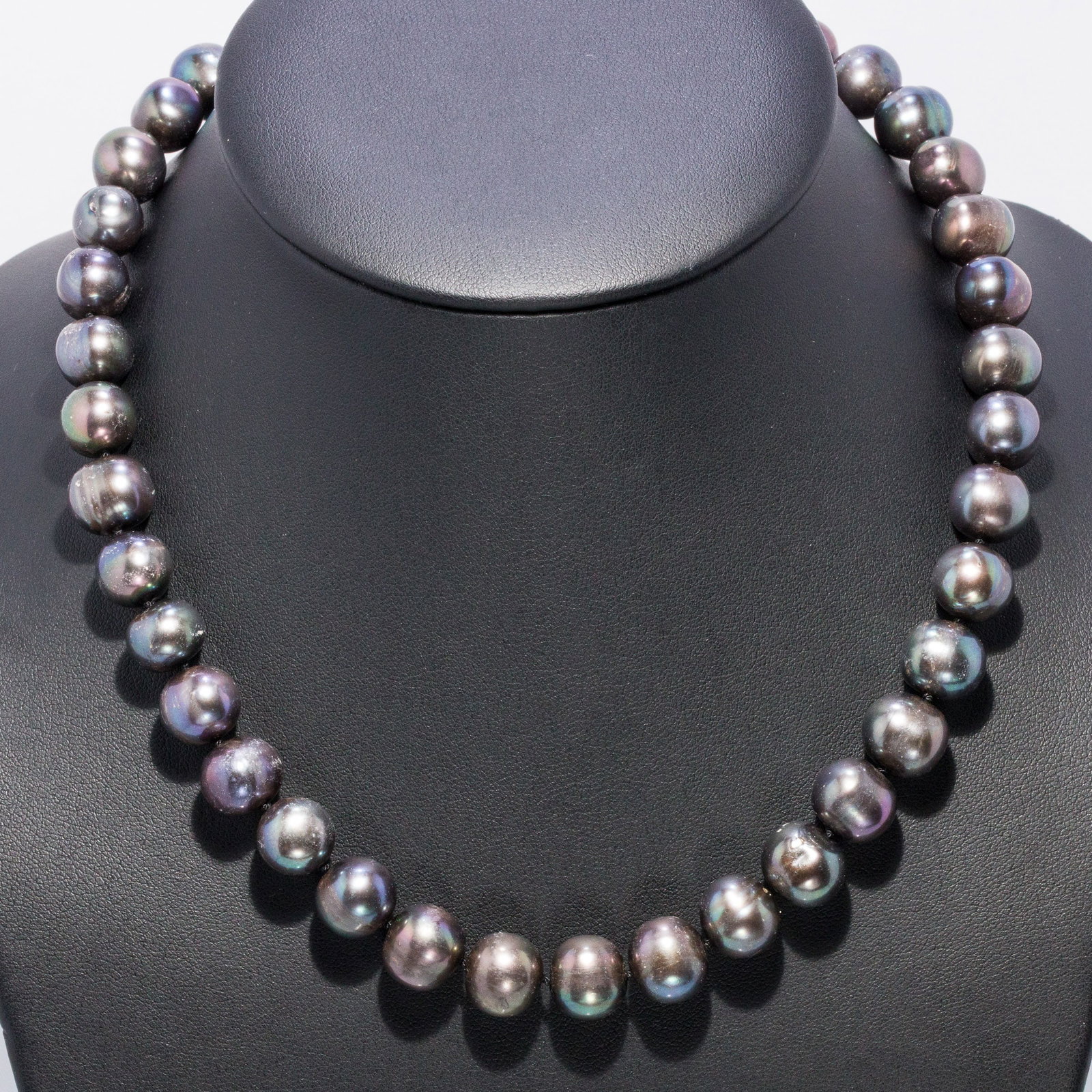 Tahitian Pearl Necklace: Description: Tahitian Pearl Necklace, strung with approx. 10-11mm Tahitian pearls with 14K white gold ball form clasp marked '585, 14K'. 76.08 grams overall. Measurements: Leng