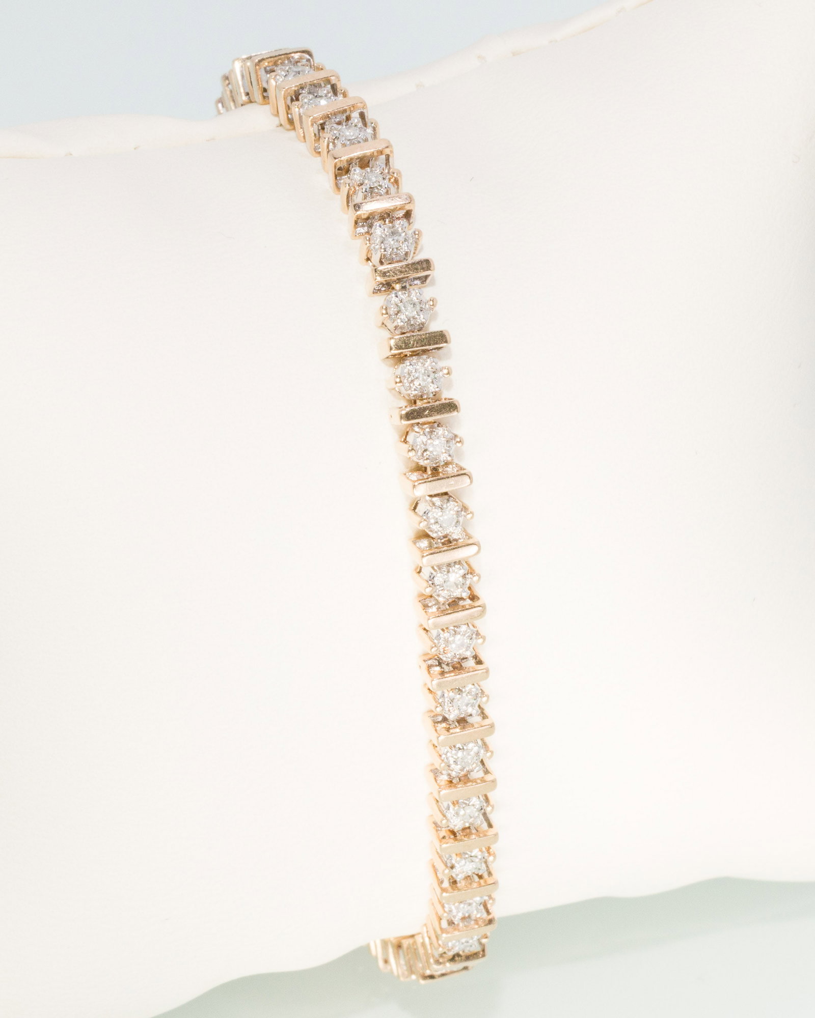 Diamond and 10K Gold Tennis Bracelet: Description: Diamond and 10K Gold Tennis Bracelet, 10K yellow gold bar links alternating with prong set round diamonds (approx. 1.8 mm), with locking clasp, marked '10KP' on one end. 11.5 grams o