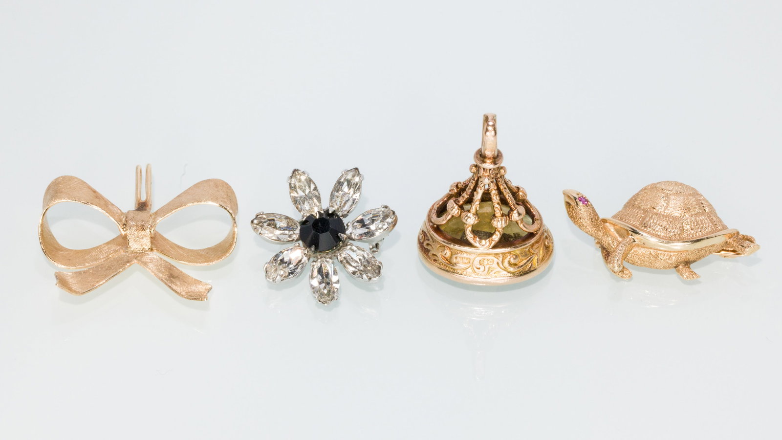 14K Turtle Pin, Bow Pendant, Topaz Fob, Crystal Pin: Property of a Private Collector, Savannah, GA Description: 14K Turtle Pin, Bow Pendant, Topaz Fob, Crystal Pin, comprising a 14K yellow gold turtle pin with ruby eye (unmarked but tests 14K); a 14