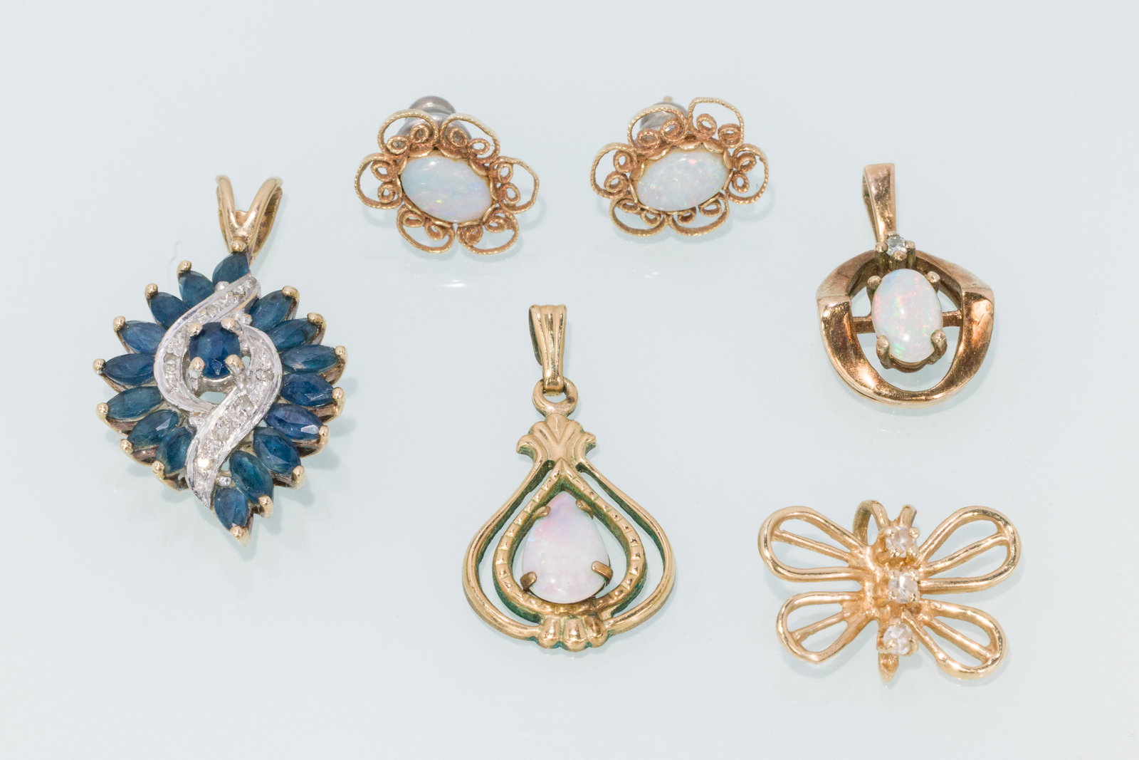 4 Gold, Sapphire, Diamond & Opal Pendants & Earrings: Description: Four Gold, Sapphire, Diamond and Opal Pendants with Opal Earrings, comprising gold filled and opal stud earrings, a yellow gold butterfly pendant with three small round cut diamonds