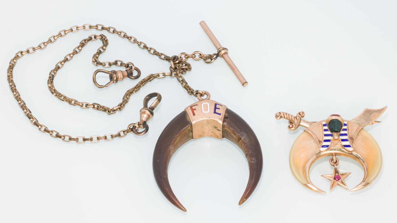 Tiger Claw Mason Pin and an Eagle Talon Fob: Property from a Private Collection, Jacksonville, FL Description: Tiger Claw Mason Pin and an Eagle Talon Fob, a 14K yellow gold pin with enamel and stone pharaoh head and two tigers claws, marked
