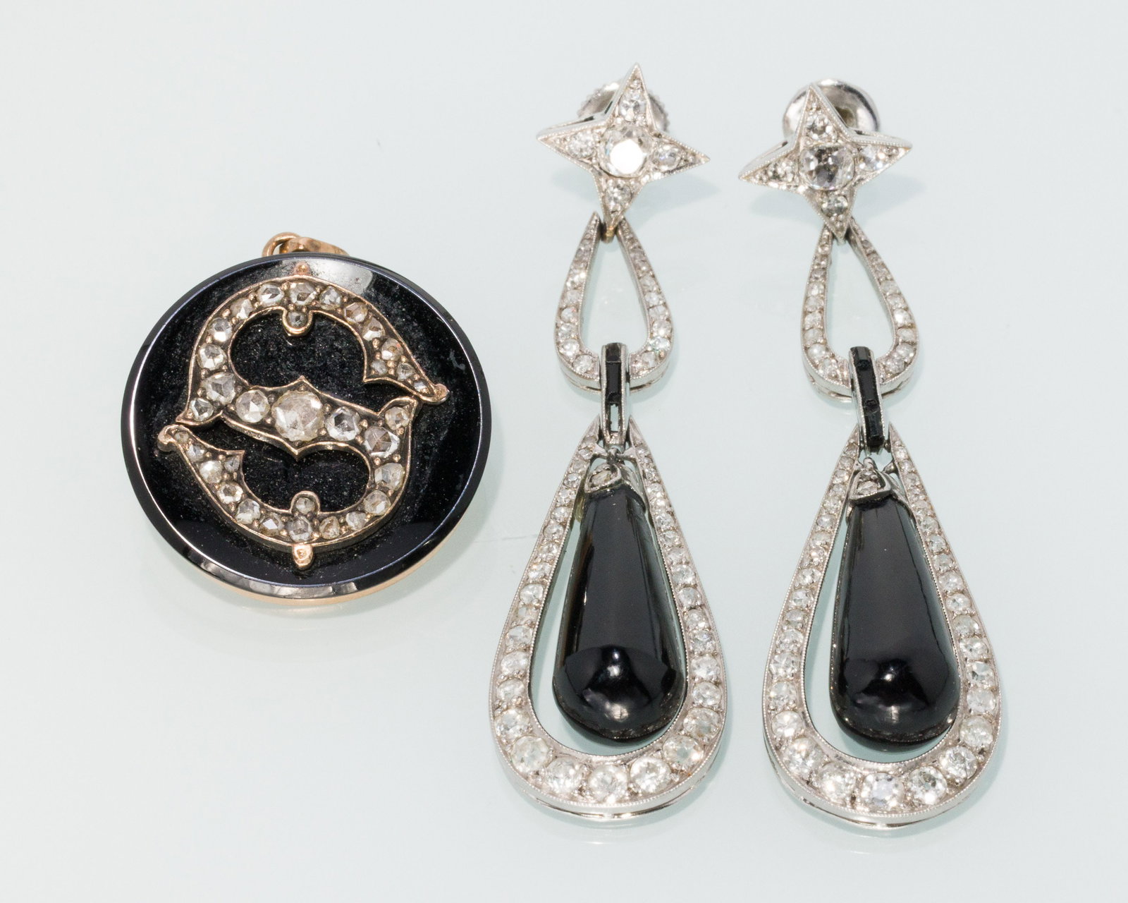 Platinum Onyx & Diamond Earrings and Pin/Pendant: Description: Pair of Platinum Onyx and Diamond Earrings and Pin/Pendant, a pair of platinum drop earrings featuring onyx drops and round cut diamonds, with twist backs, along with a round onyx pi