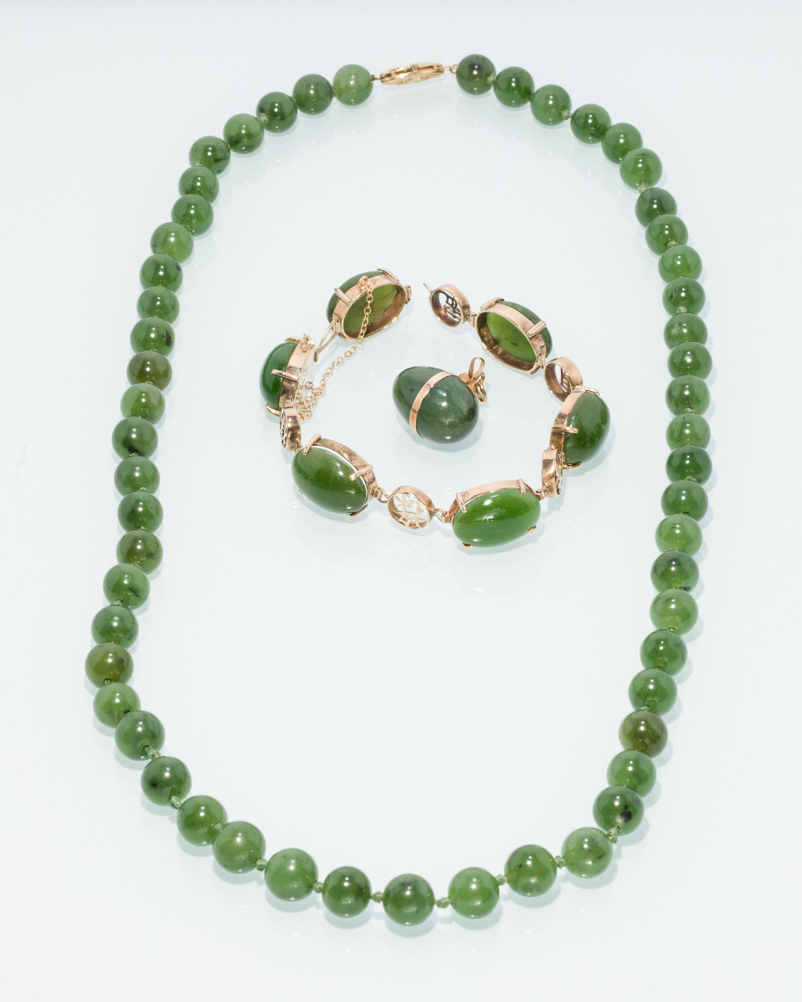 14K Jade Bracelet, Pendant and Necklace: Property of a Private Collector, Savannah, GA Description: 14K Jade Bracelet, Pendant and Necklace, comprising a beaded jade necklace with 14K clasp (22 in. long), an egg-form jade and 14K gold pe