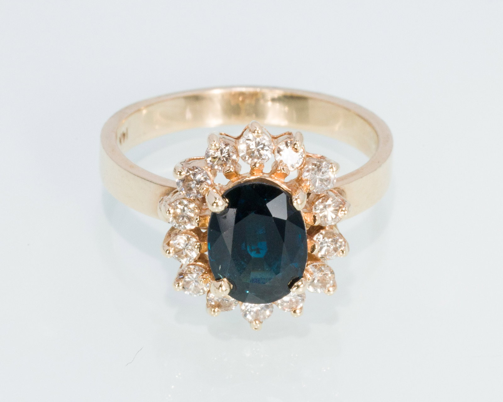 14K Sapphire Ring with Diamond Halo, Size 6: Description: 14K Sapphire Ring with Diamond Halo, Size 6, 14K yellow gold ring featuring an oval cut dark blue sapphire with diamond halo, marked 14K. 3.68 grams overall. Measurements: