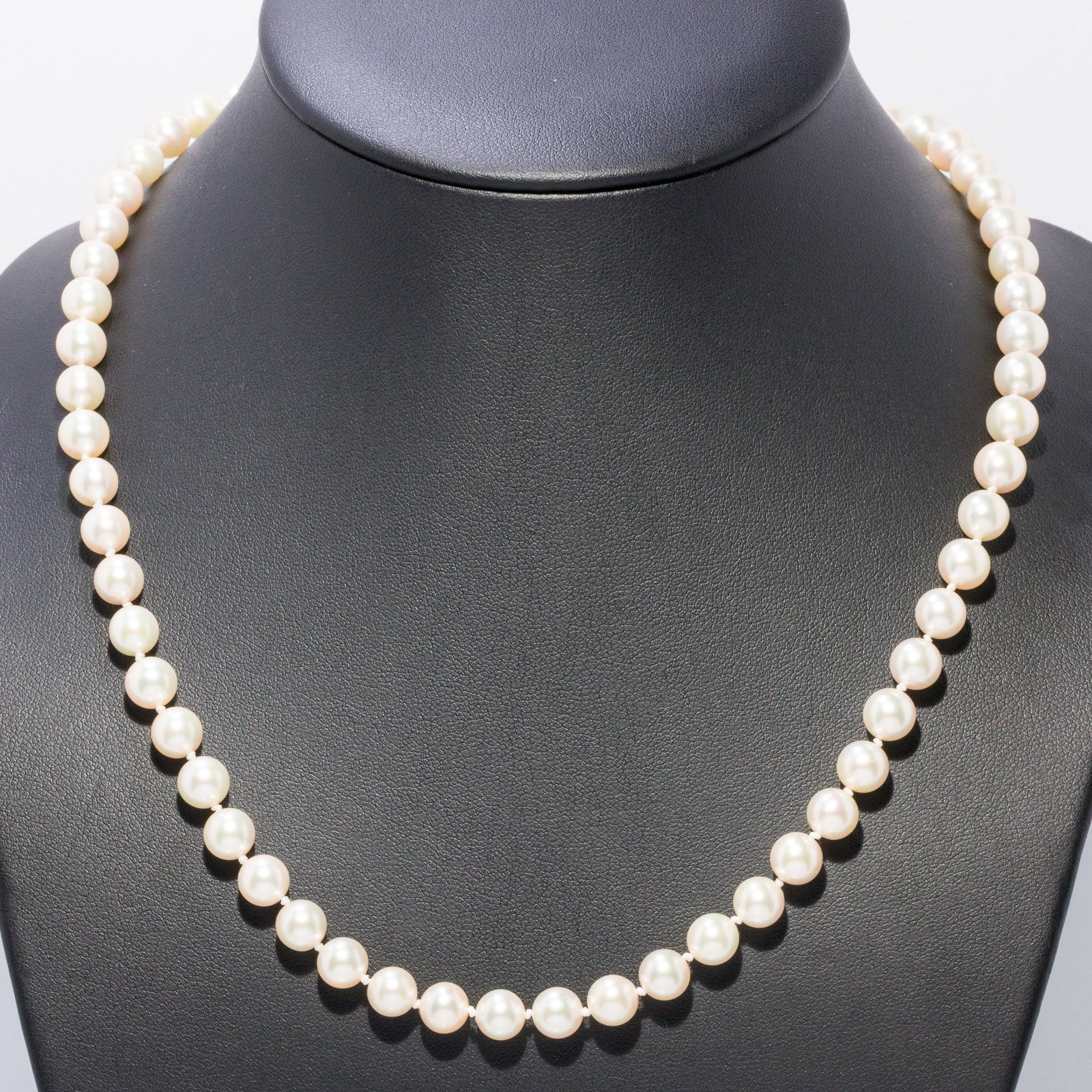 Matinee Length Pearl Necklace with 14K Clasp: Description: Matinee Length Pearl Necklace with 14K Clasp, matinee length, strung with approx. 7 mm pearls with 14K yellow gold clasp, marked 14K on one side of clasp. Measurements: