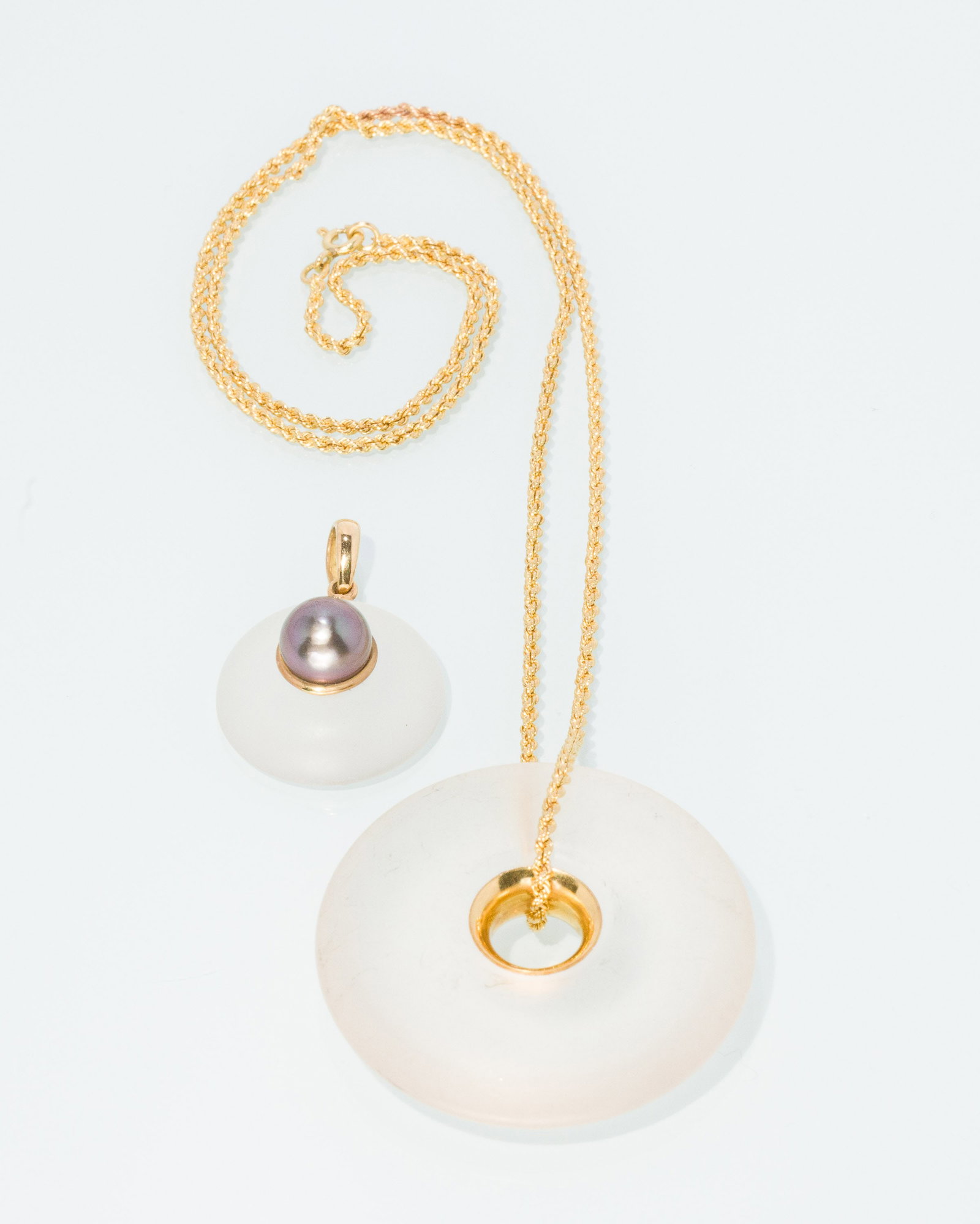 Two Pendants and 18K Gold Chain: Description: Two Pendants and 18K Gold Chain, comprising a frosted glass ring pendant with '900' gold interior on a 18K braided gold chain (marked '750' on clasp, and '900' on interior of ring) t