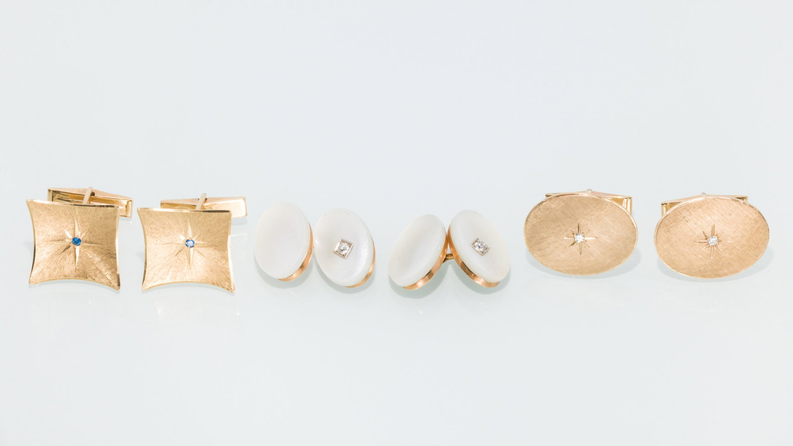 Group of Three 14K Gold Cufflinks: Property from a Private Collection, Jacksonville, FL Description: Group of Three 14K Gold Cufflinks, comprising a pair of yellow gold oval cufflinks each featuring a round diamond, hallmarked 's'