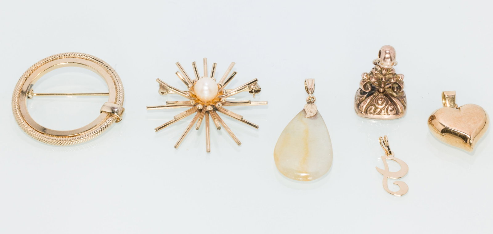 Two Gold Brooch and 3 Charms: Property of a Private Collector, Savannah, GA Description: Two Gold Brooch and 3 Charms, comprising a yellow gold circular brooch (marked 'Winard, 1/20, 12KGF'); a yellow gold and pearl starburst-