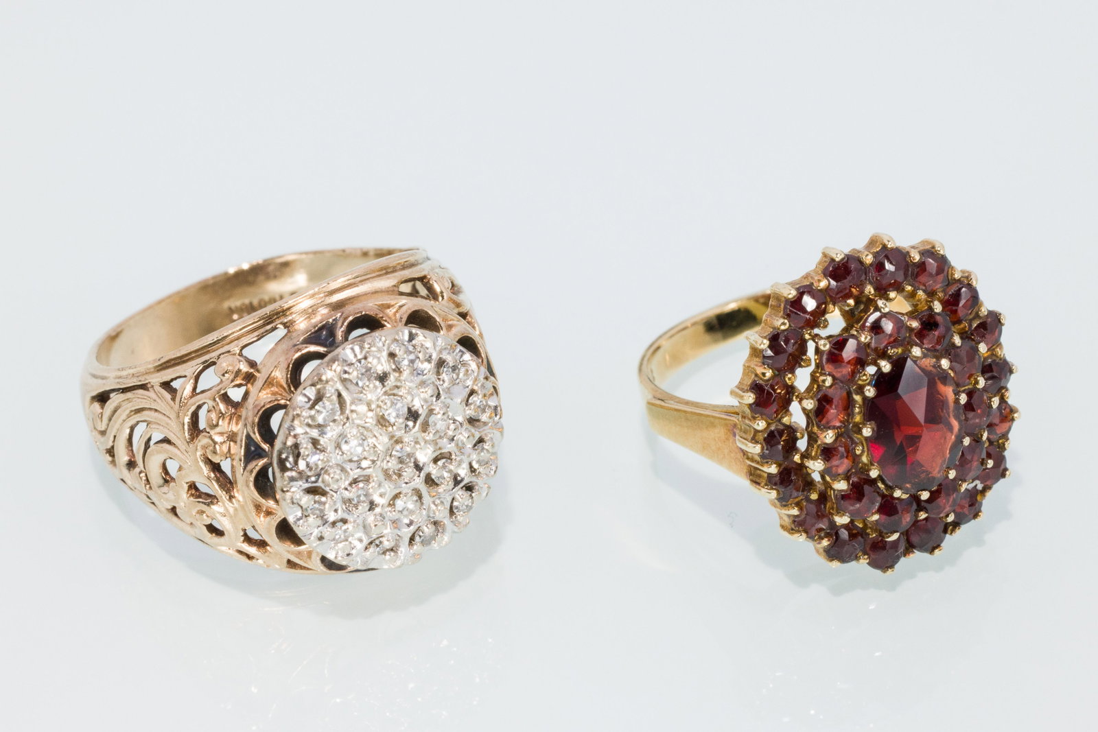 Two Ladies Vintage Rings: Property from a Private Collection, Jacksonville, FL Description: Two Ladies Vintage Rings, a 10K yellow gold bohemian style garnet ring, marked 10K, size 7.25, along with a 10K cluster diamond ri